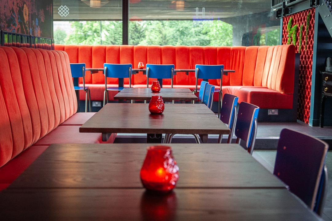 Chinatown HUCKSTER London: cozy red booths, ideal for social events and networking.