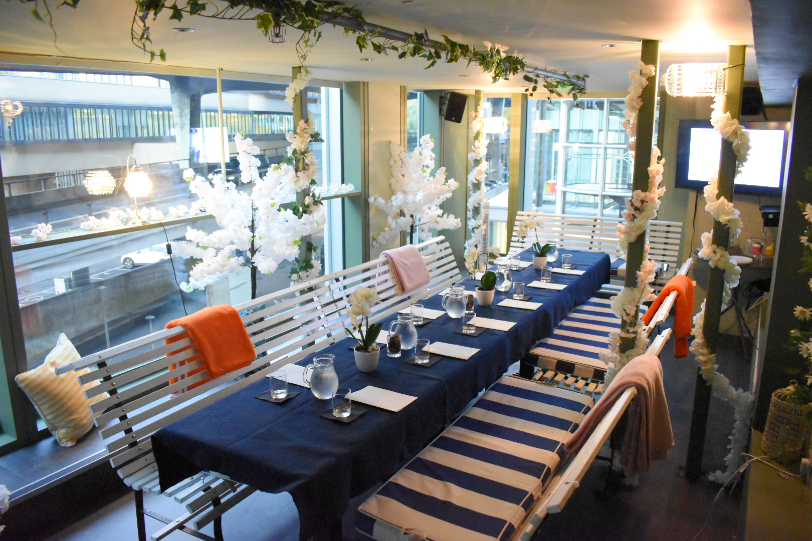 Stylish meeting space in HUCKSTER London with elegant floral decor and modern lighting.