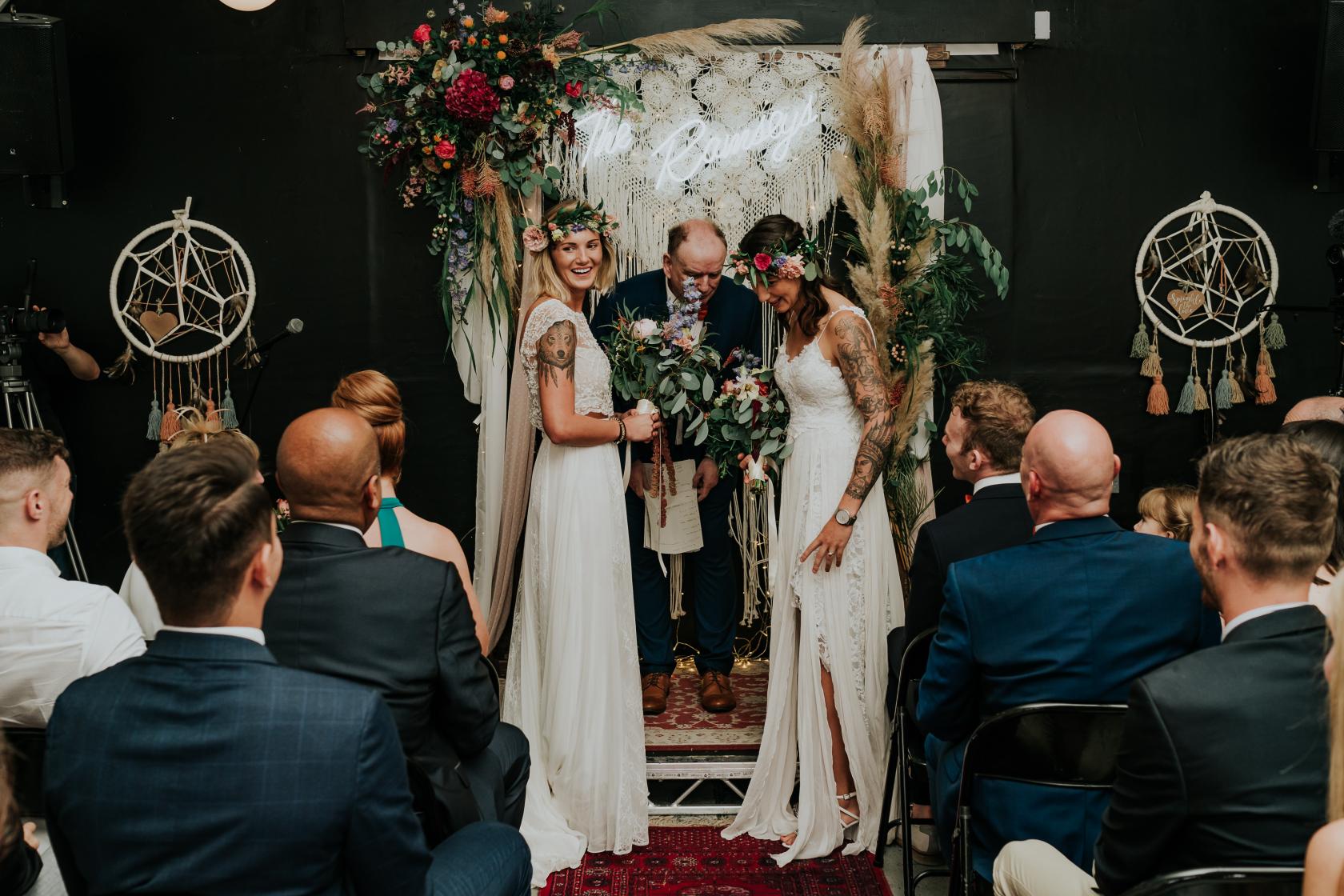 "Intimate wedding ceremony with two brides at Springs Studio, Peckham Springs, in elegant decor."