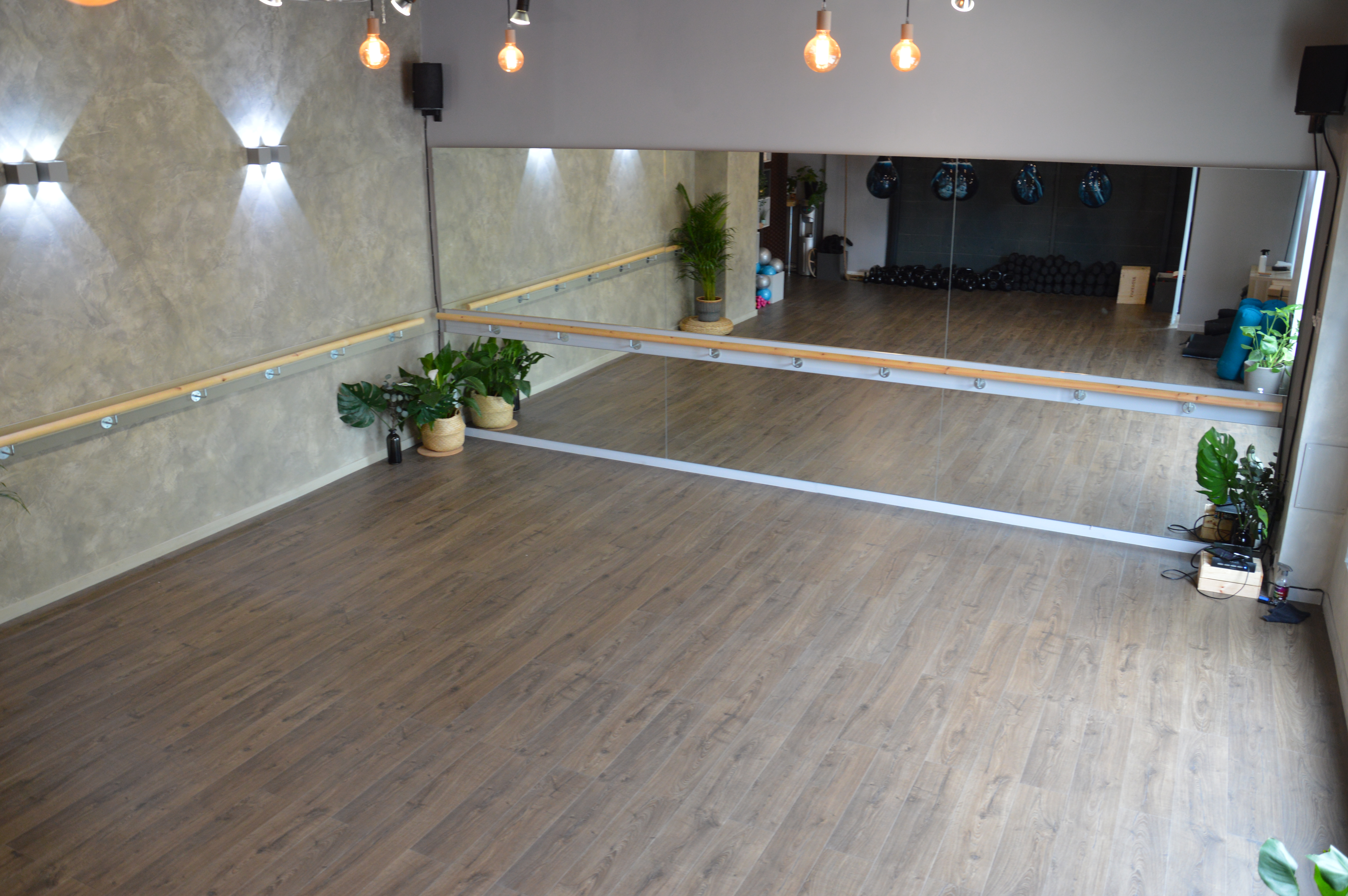 Versatile event space with polished wooden floor, ideal for dance classes and workshops.