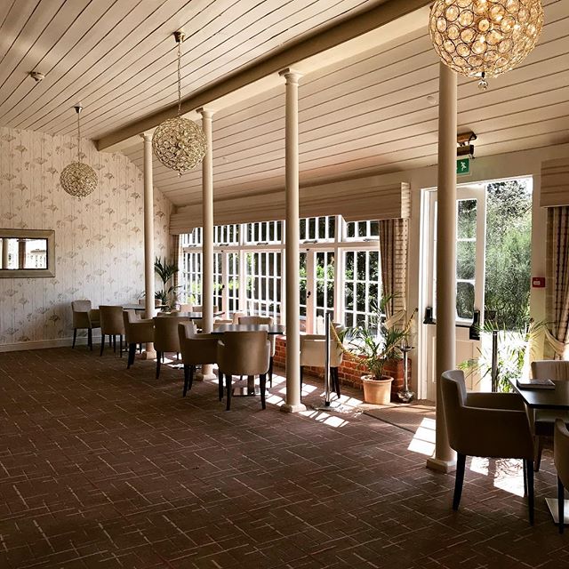 Bright event space at The Coach House with large windows, ideal for workshops and gatherings.