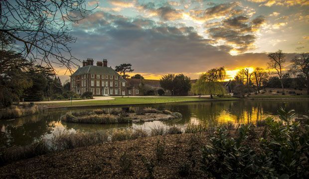 The Coach House venue with mansion at sunset, ideal for weddings and outdoor events.