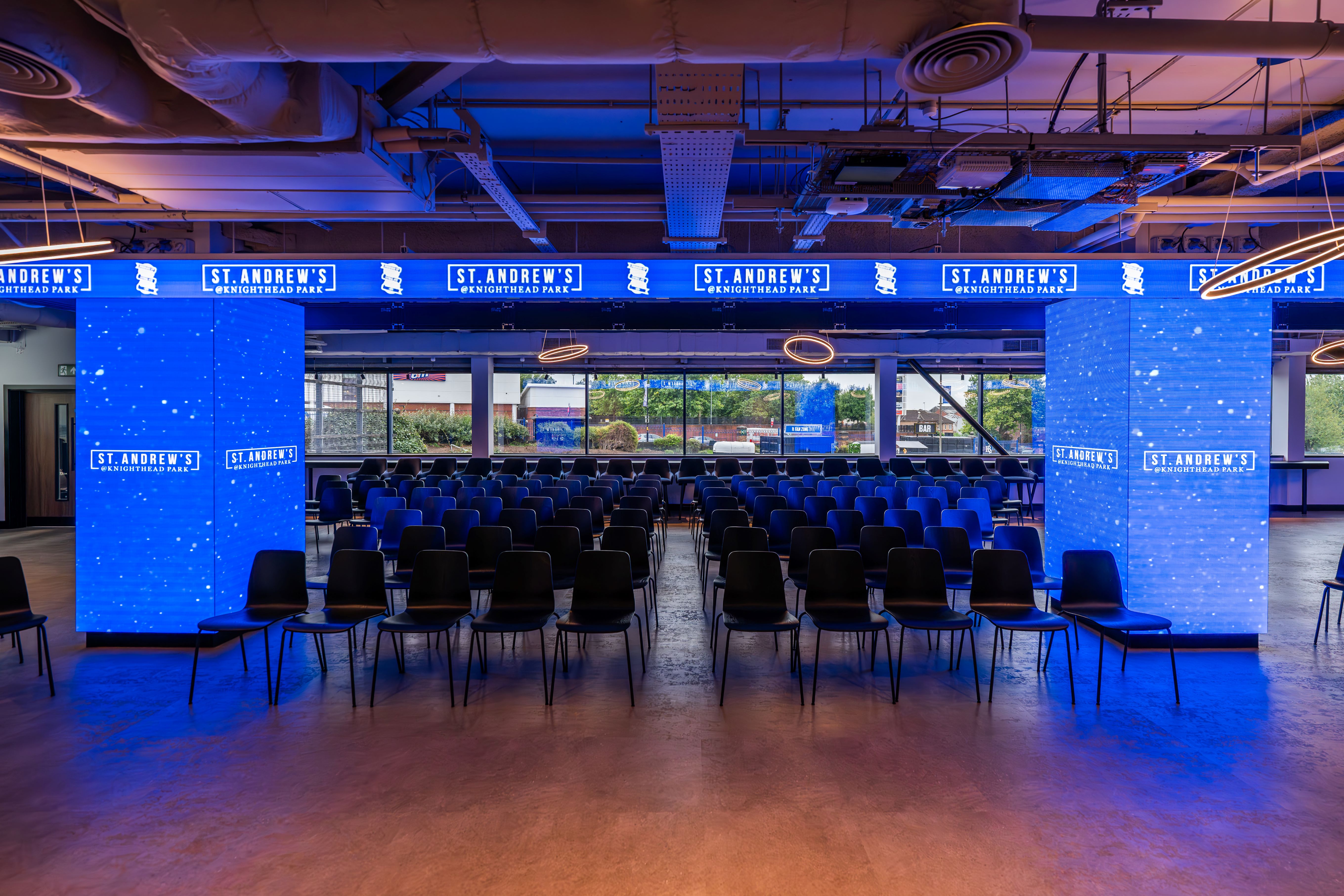 Sponsors Lounge at Birmingham City FC, modern event space with blue lighting for conferences.