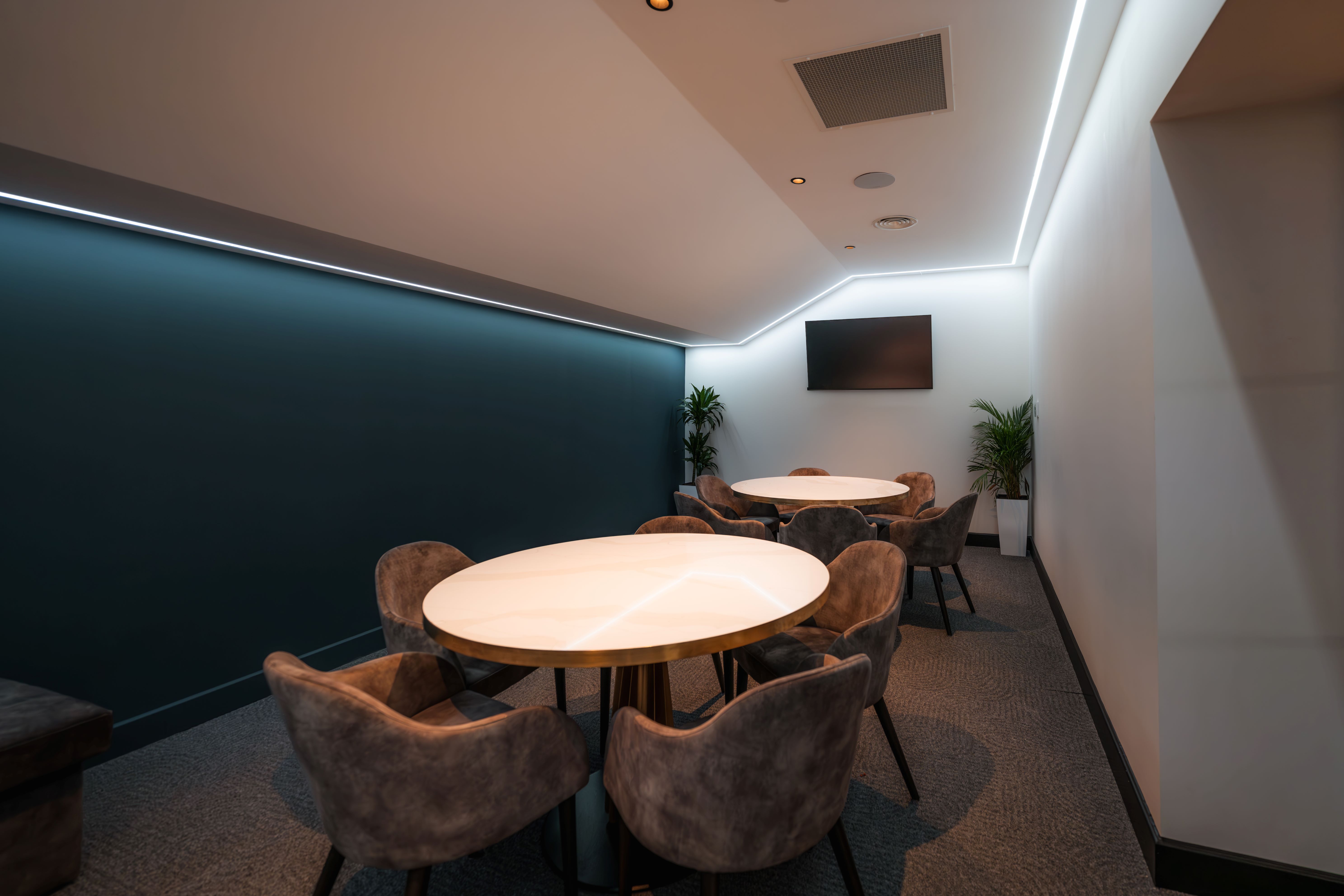 Modern meeting room at Birmingham City FC with round tables for collaborative events.