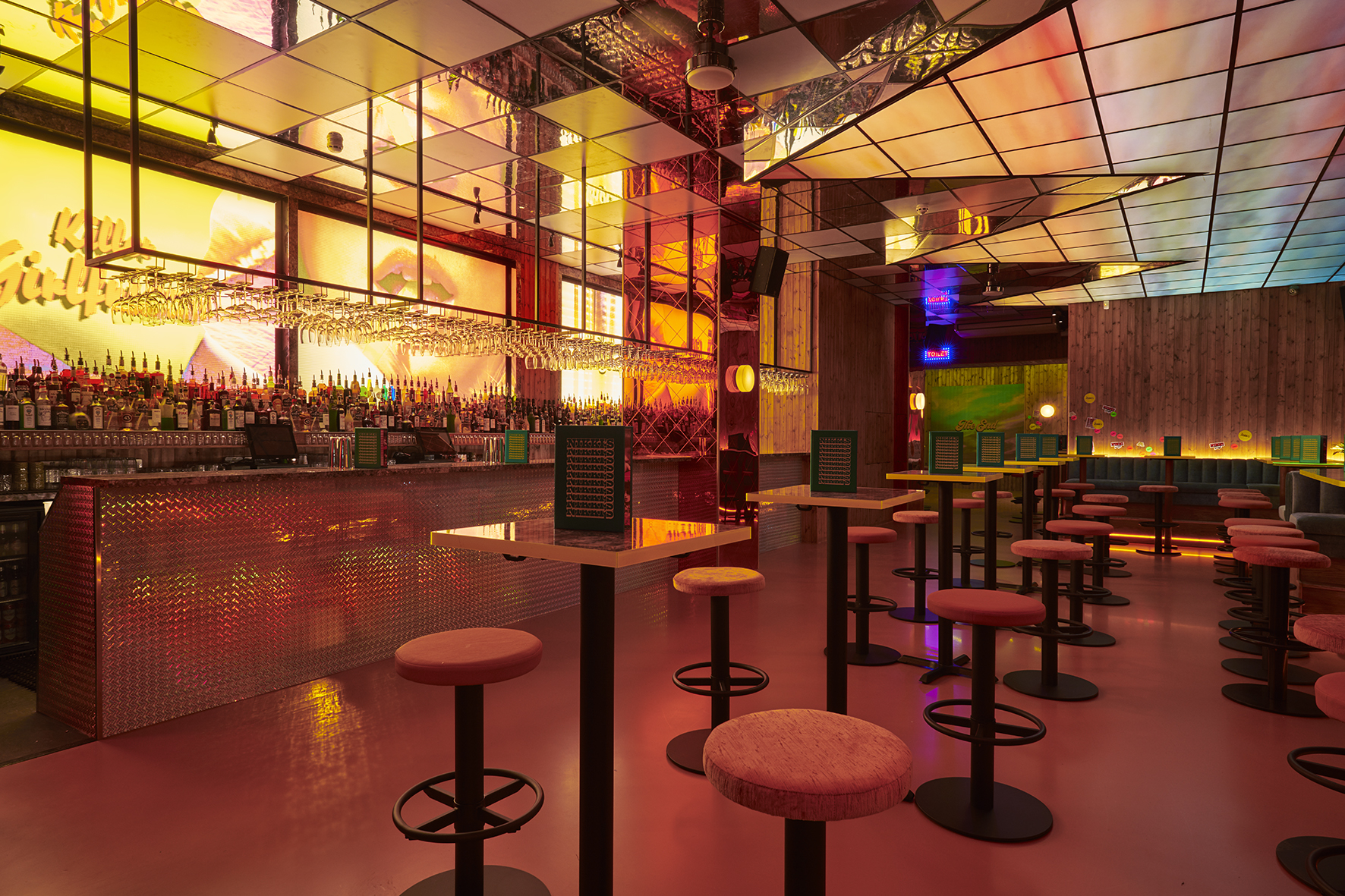 Vibrant bar venue with colorful lighting, perfect for networking events and social gatherings.