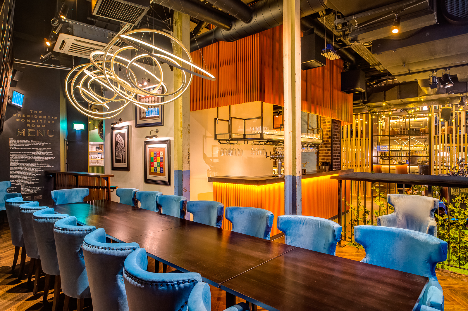 Elegant event space with plush blue chairs, perfect for corporate meetings and gatherings.