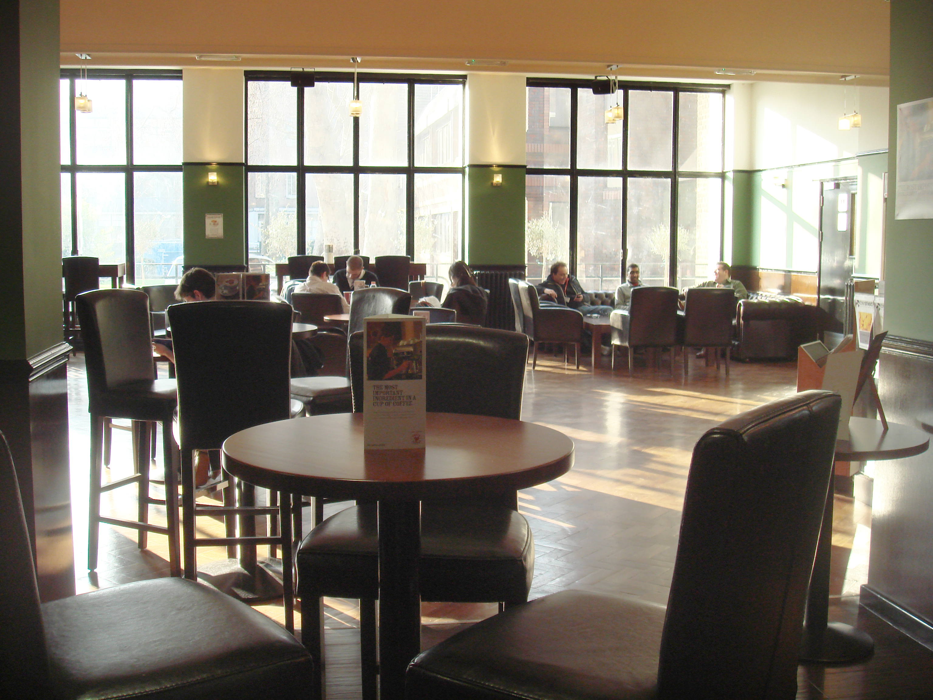 Spacious Main Bar Cafe with natural light, perfect for networking events and meetings.