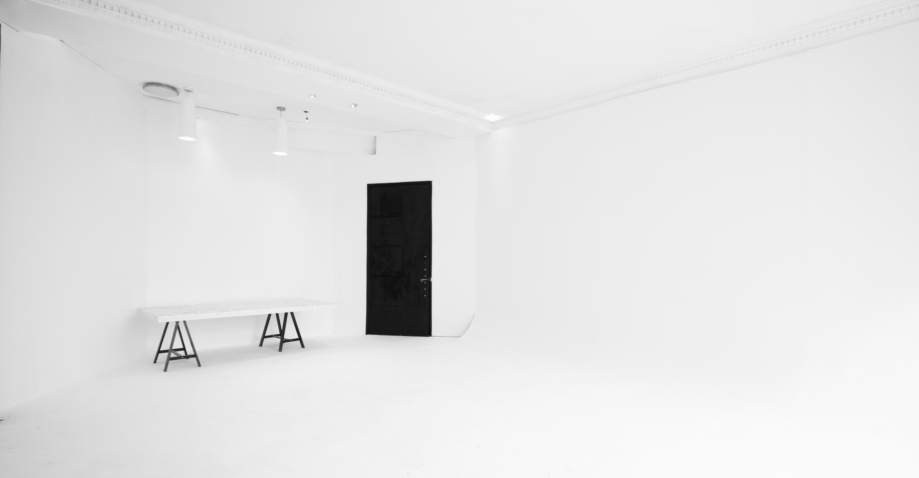 Minimalist event space in Wimbledon with white interior, ideal for corporate meetings and workshops.