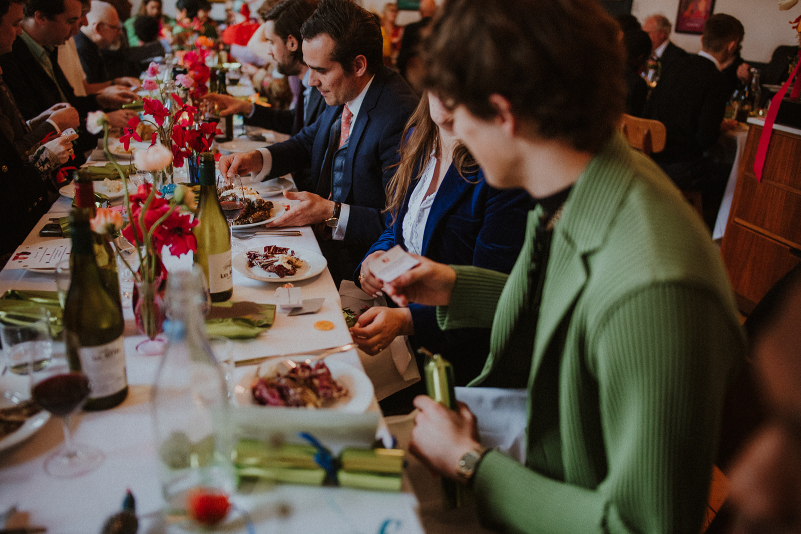 Elegant dining event in The Upstairs Room with floral centerpieces and professional attire.