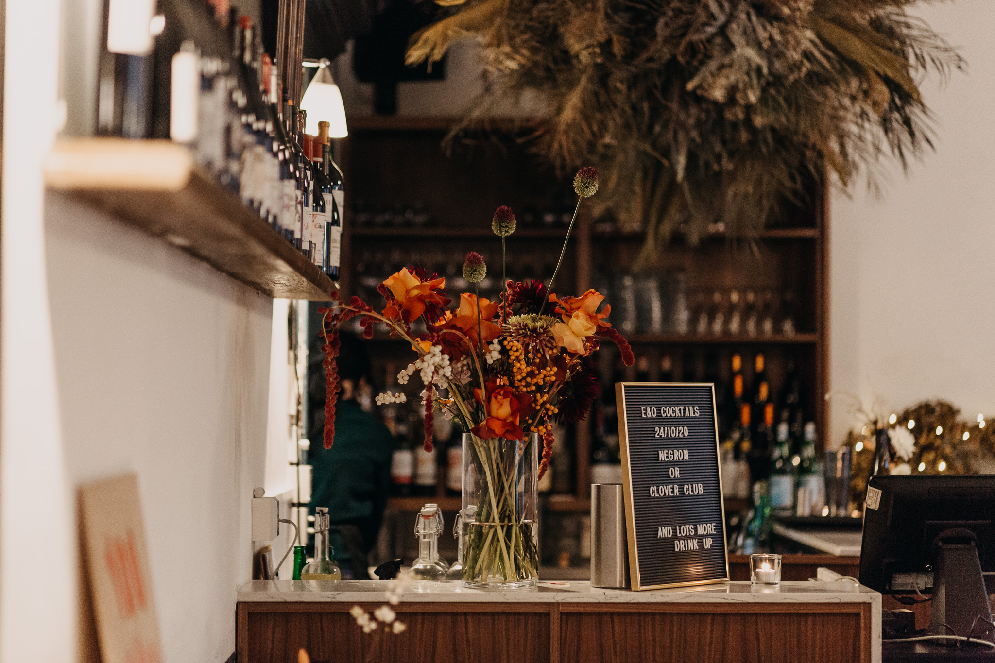 Stylish bar setup with floral arrangement for events at The Camberwell Arms.