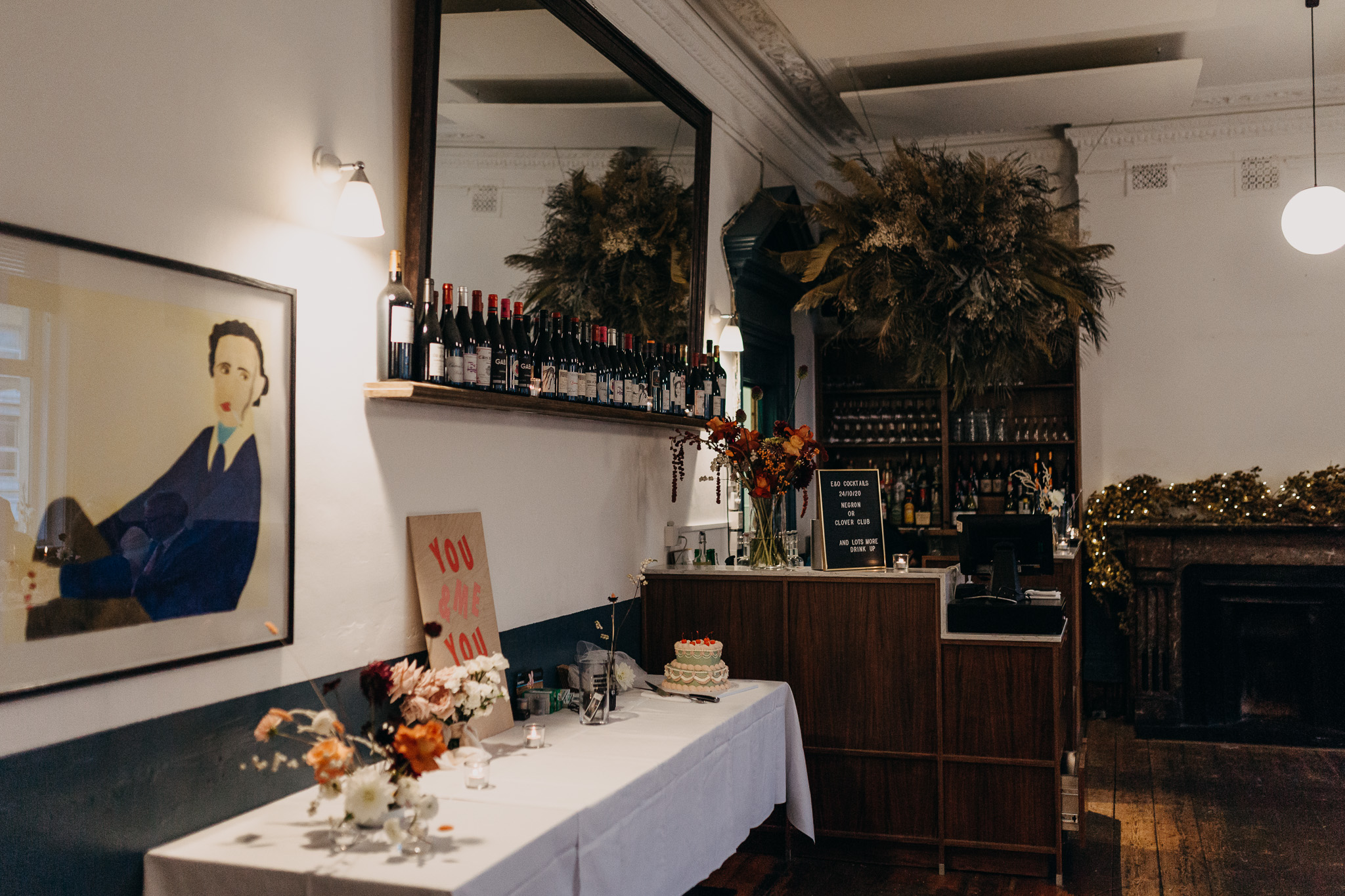 Stylish event space at The Camberwell Arms with elegant bar and floral decor.