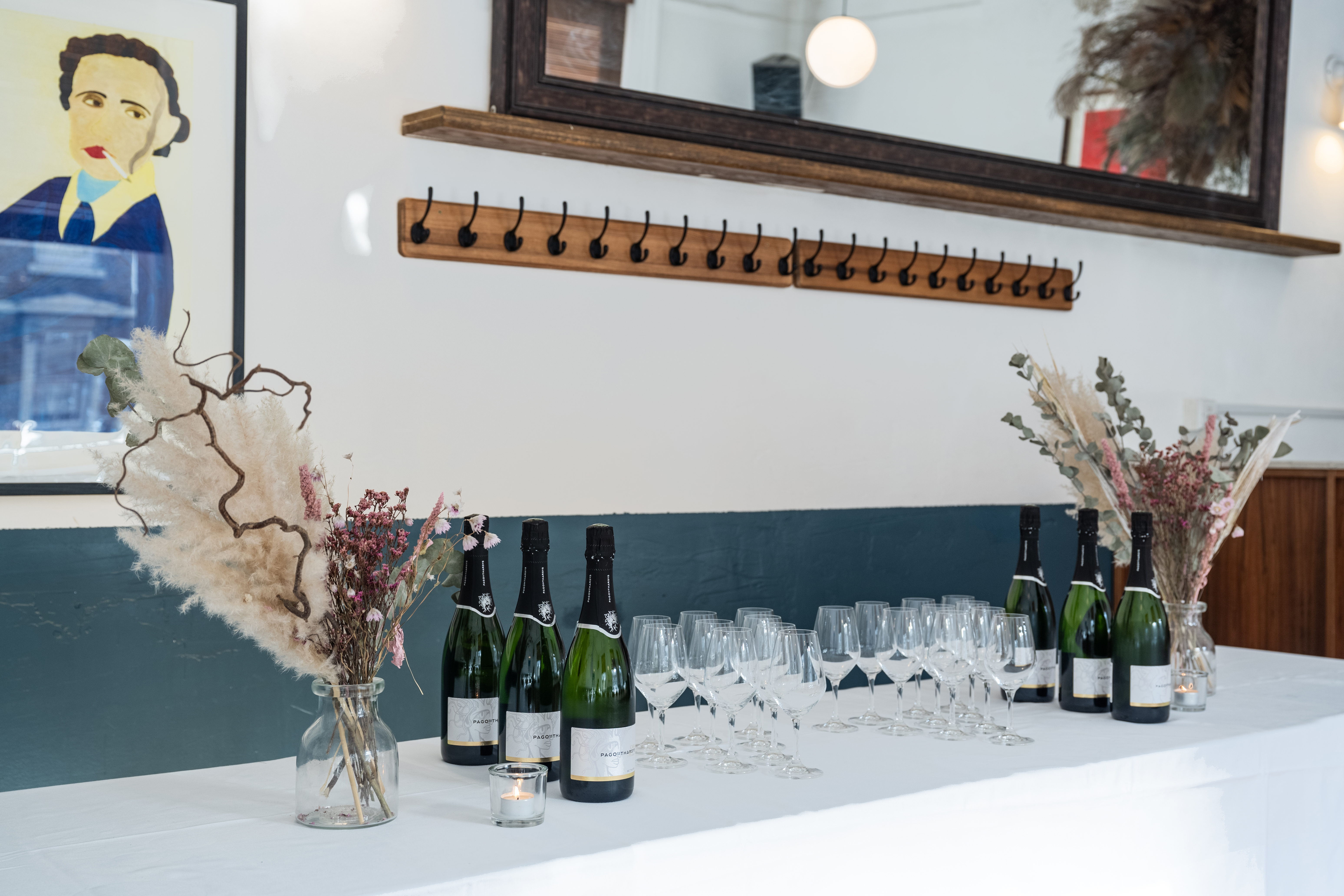 Stylish event setup in The Upstairs Room, Camberwell Arms with champagne and floral decor.