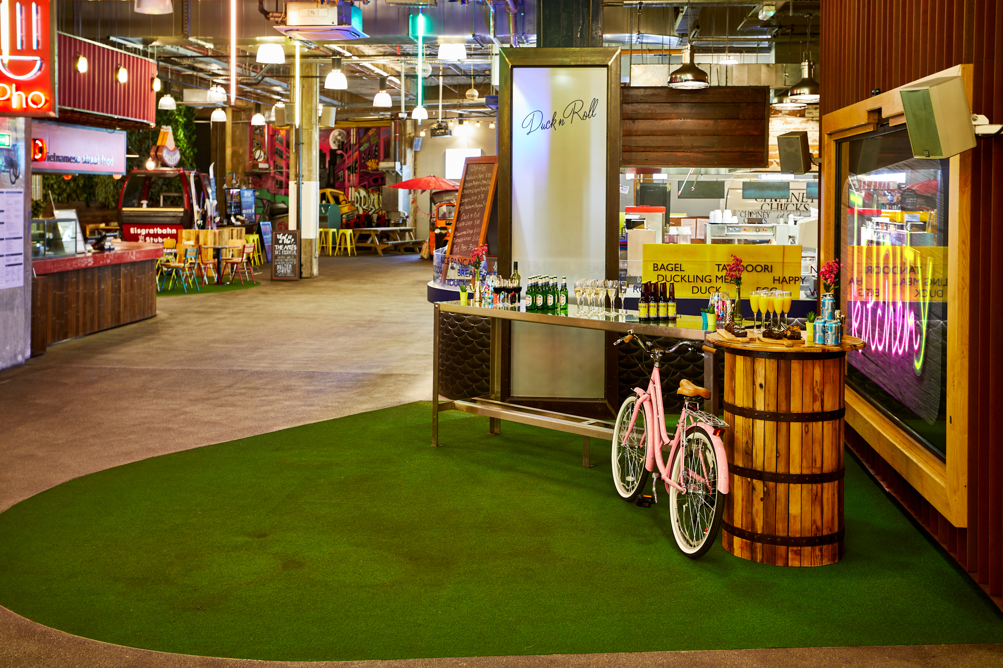 Vibrant Trinity Kitchen event space with greenery, ideal for networking and casual gatherings.