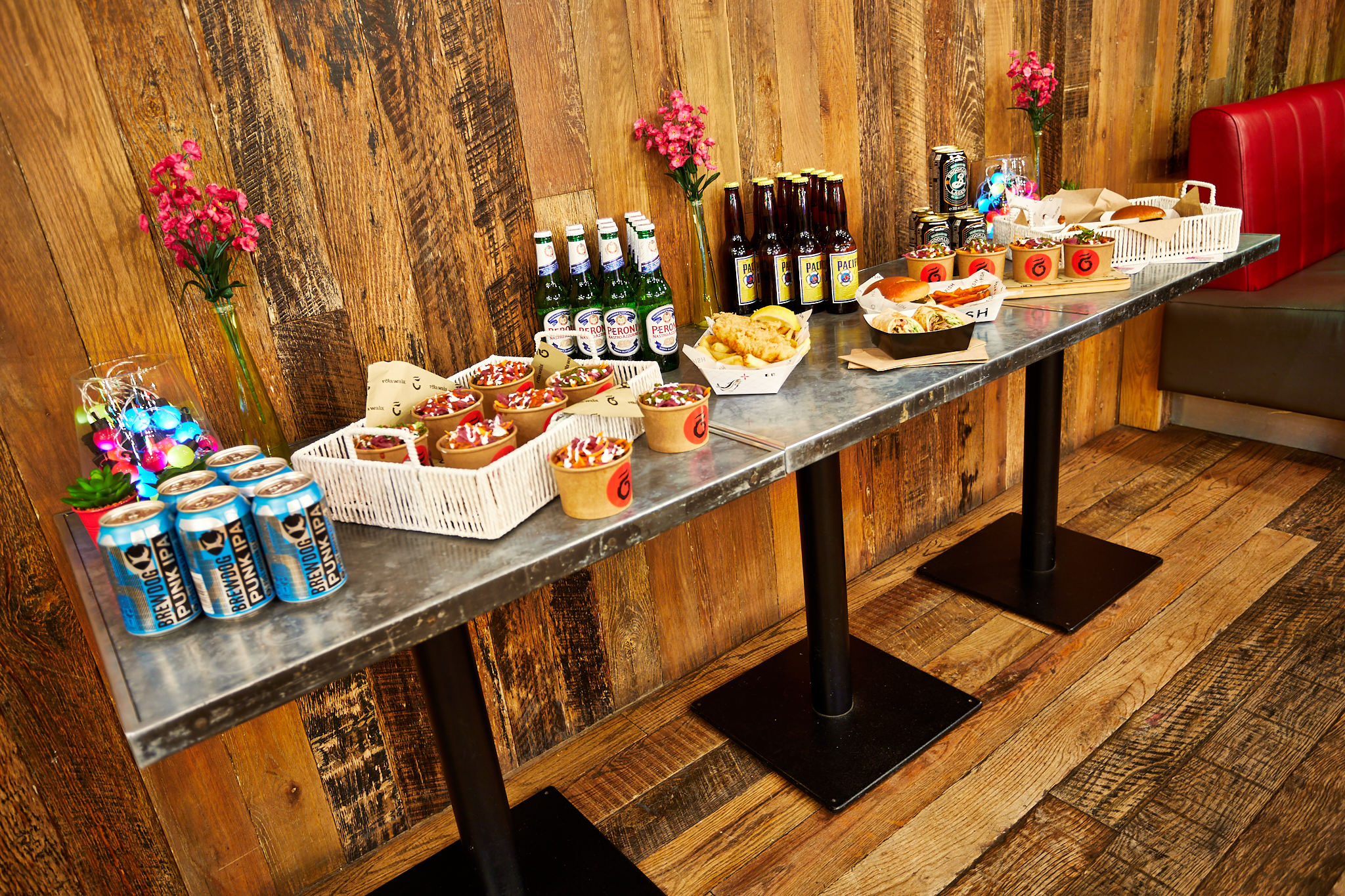 Urban courtyard refreshment station with snacks and drinks for casual events.