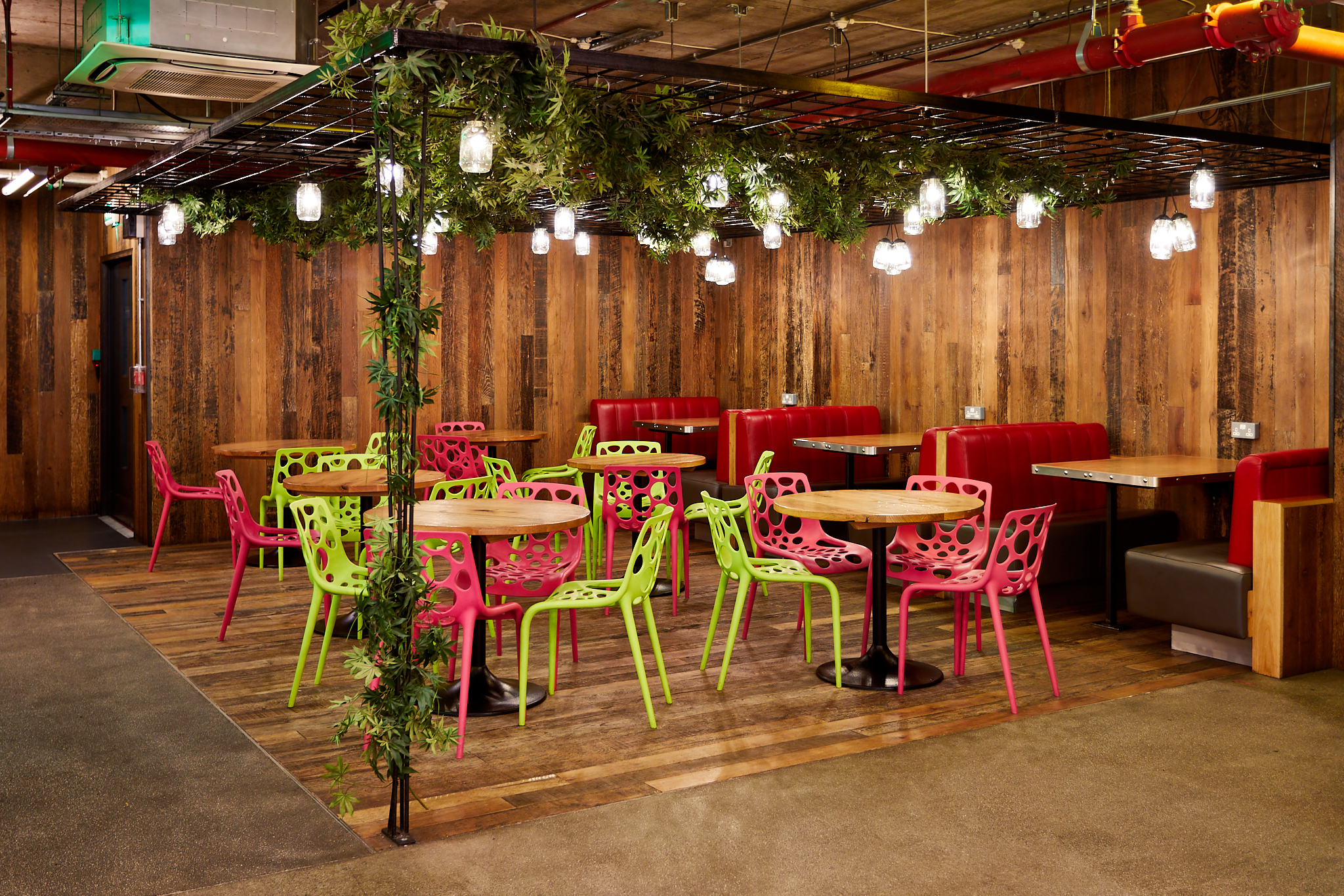 Vibrant urban courtyard with colorful seating for creative gatherings and events.