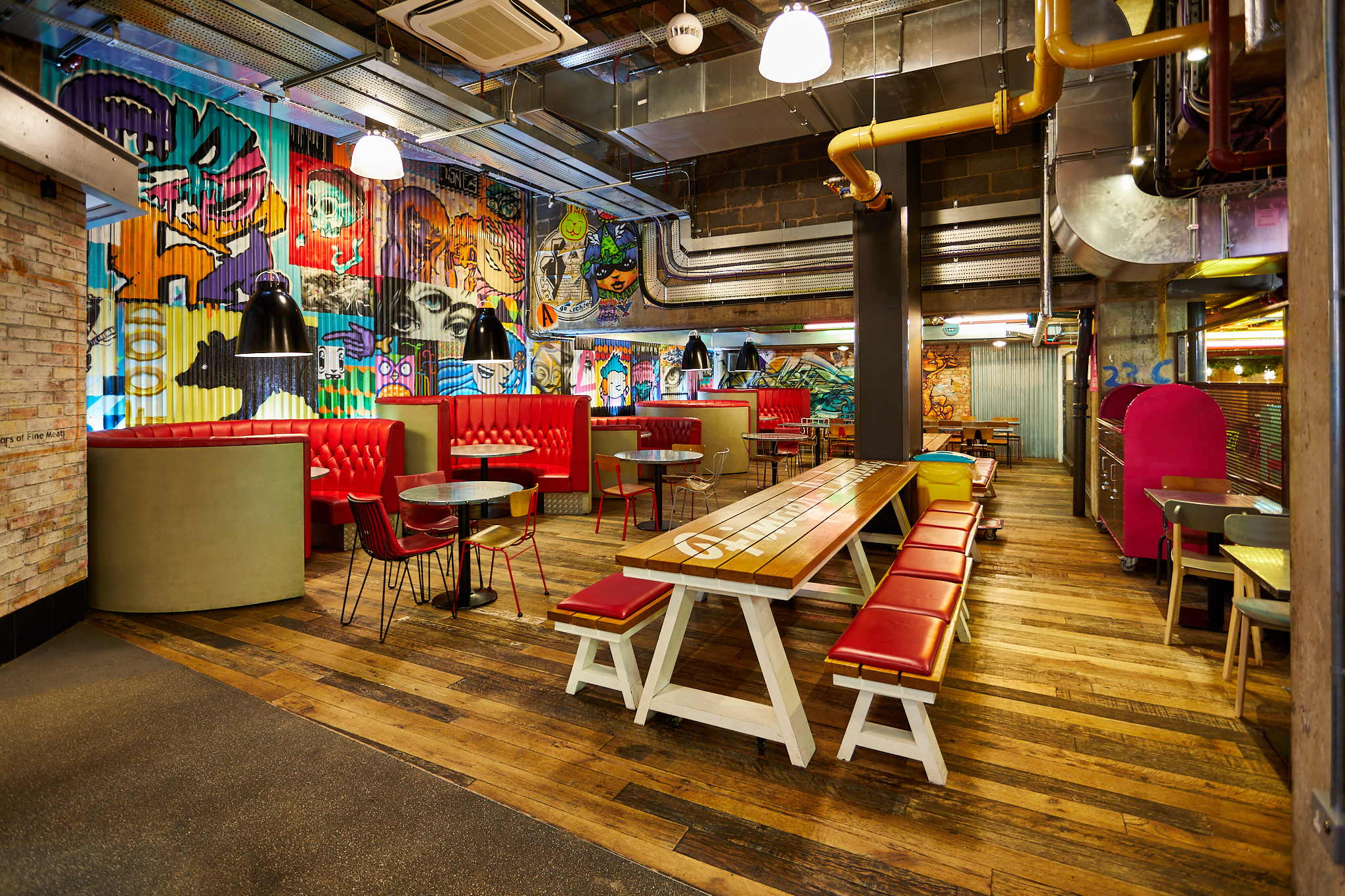 Vibrant urban courtyard with graffiti art, ideal for networking and creative events.