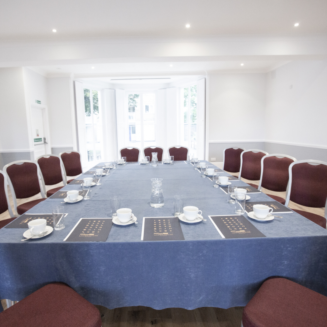 Ballroom at Linden House with elegant blue tablecloth for professional meetings.