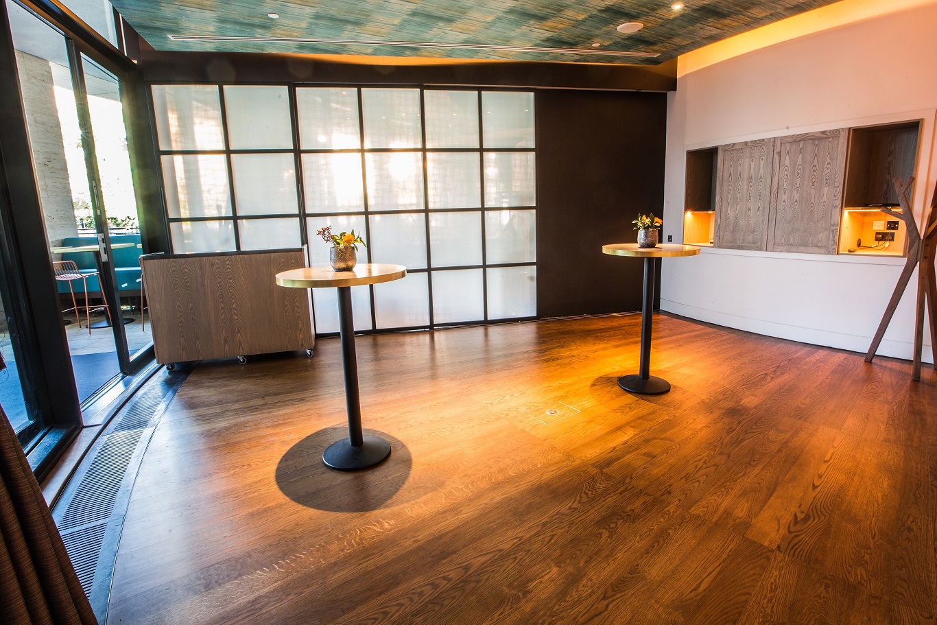 Private dining room with polished wooden floors, ideal for networking events and receptions.