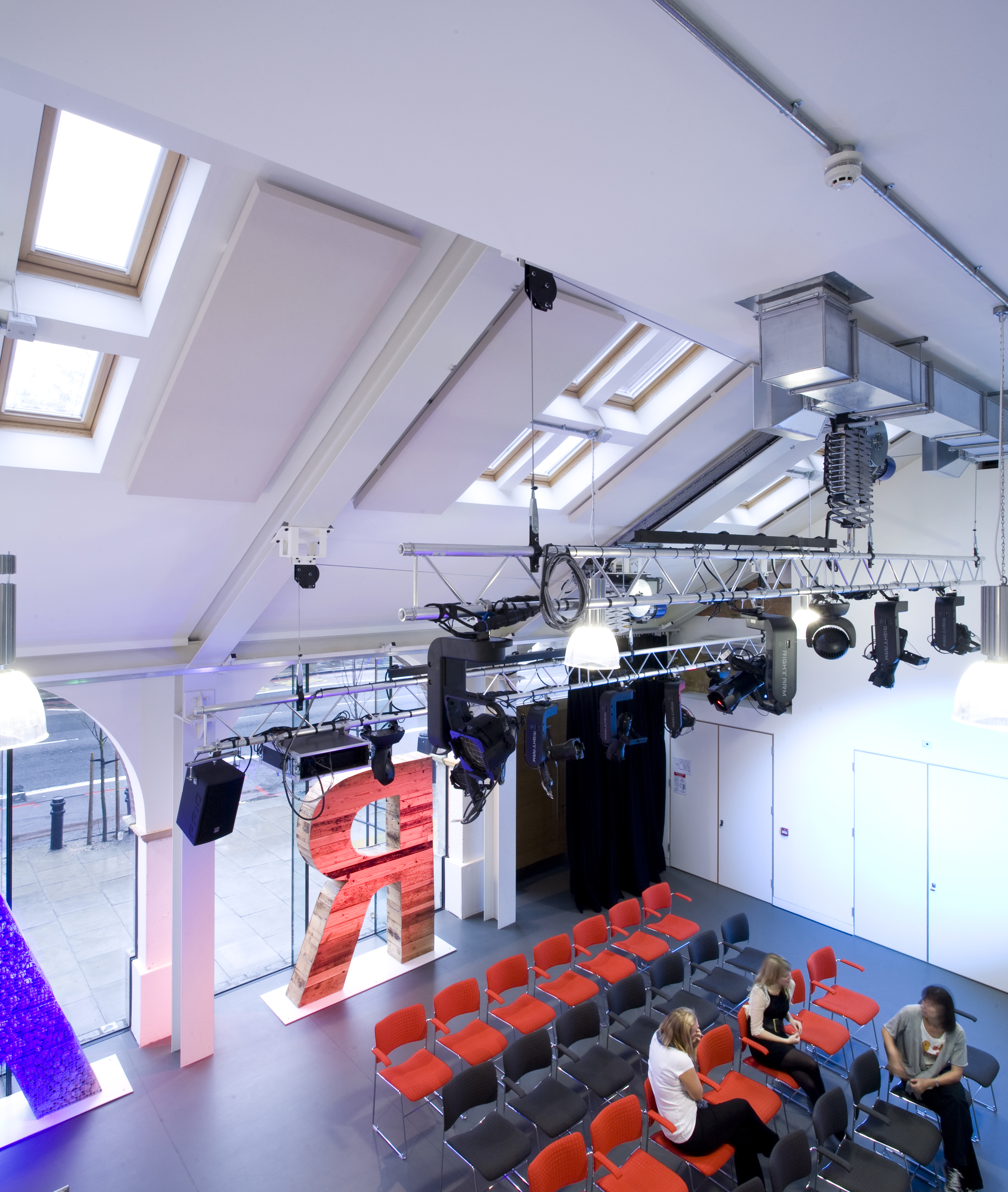 Rehearsal Room at Graeae Theatre: modern event space with red chairs for presentations.