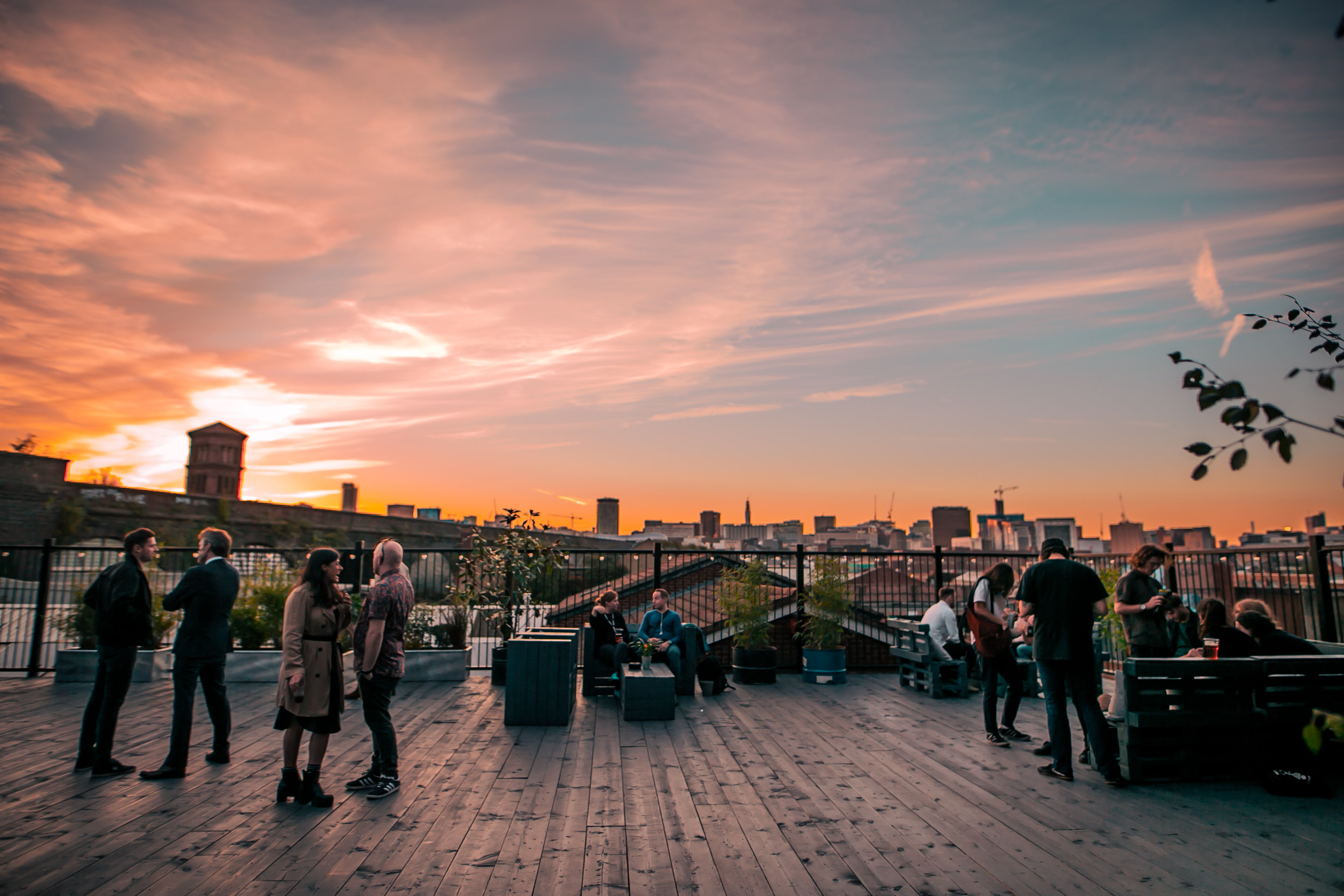 Vibrant rooftop event space at XOYO Birmingham with stunning sunset backdrop, ideal for gatherings.