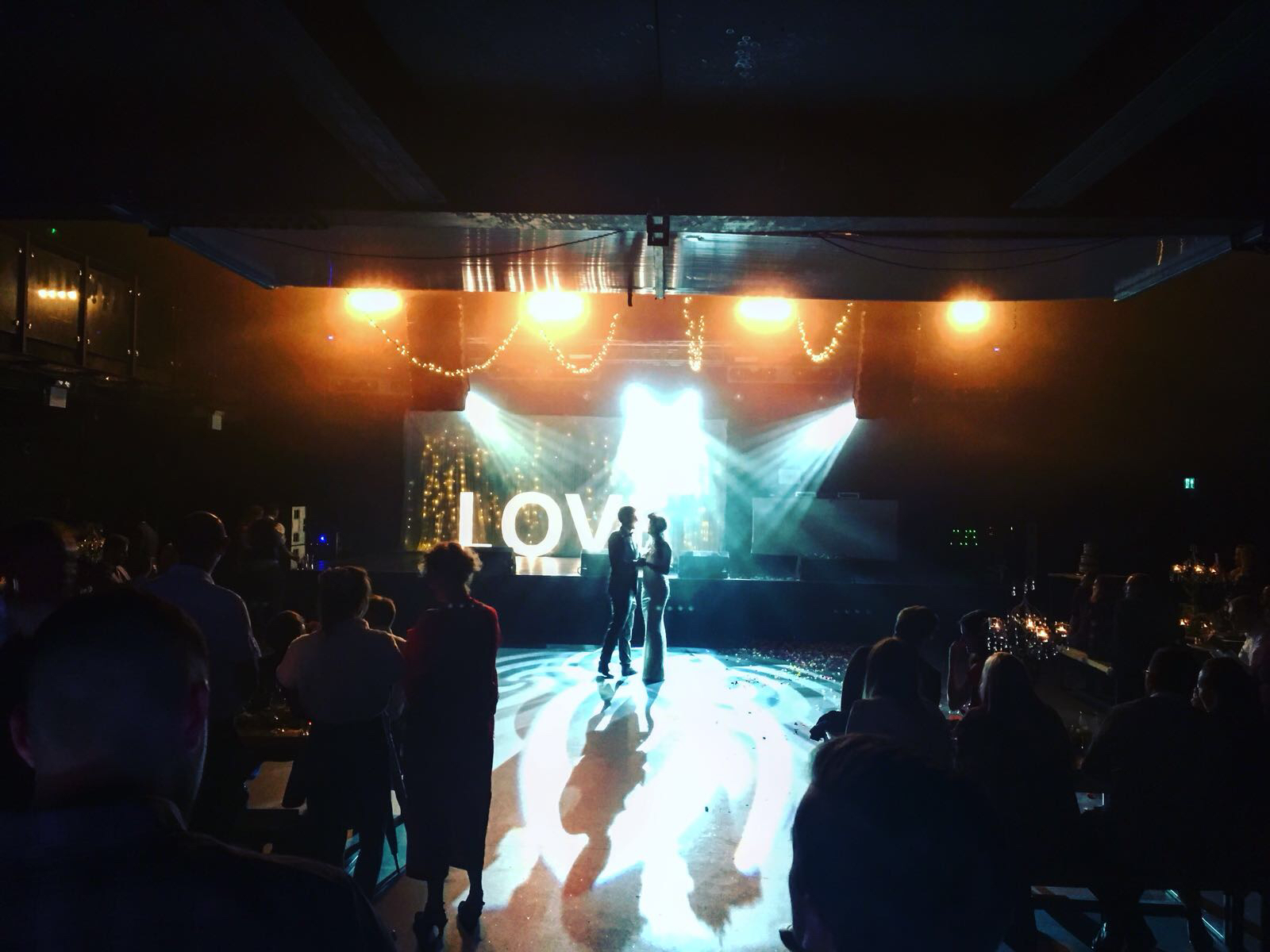 Atmospheric XOYO Birmingham main room with romantic "LOVE" backdrop for weddings or events.