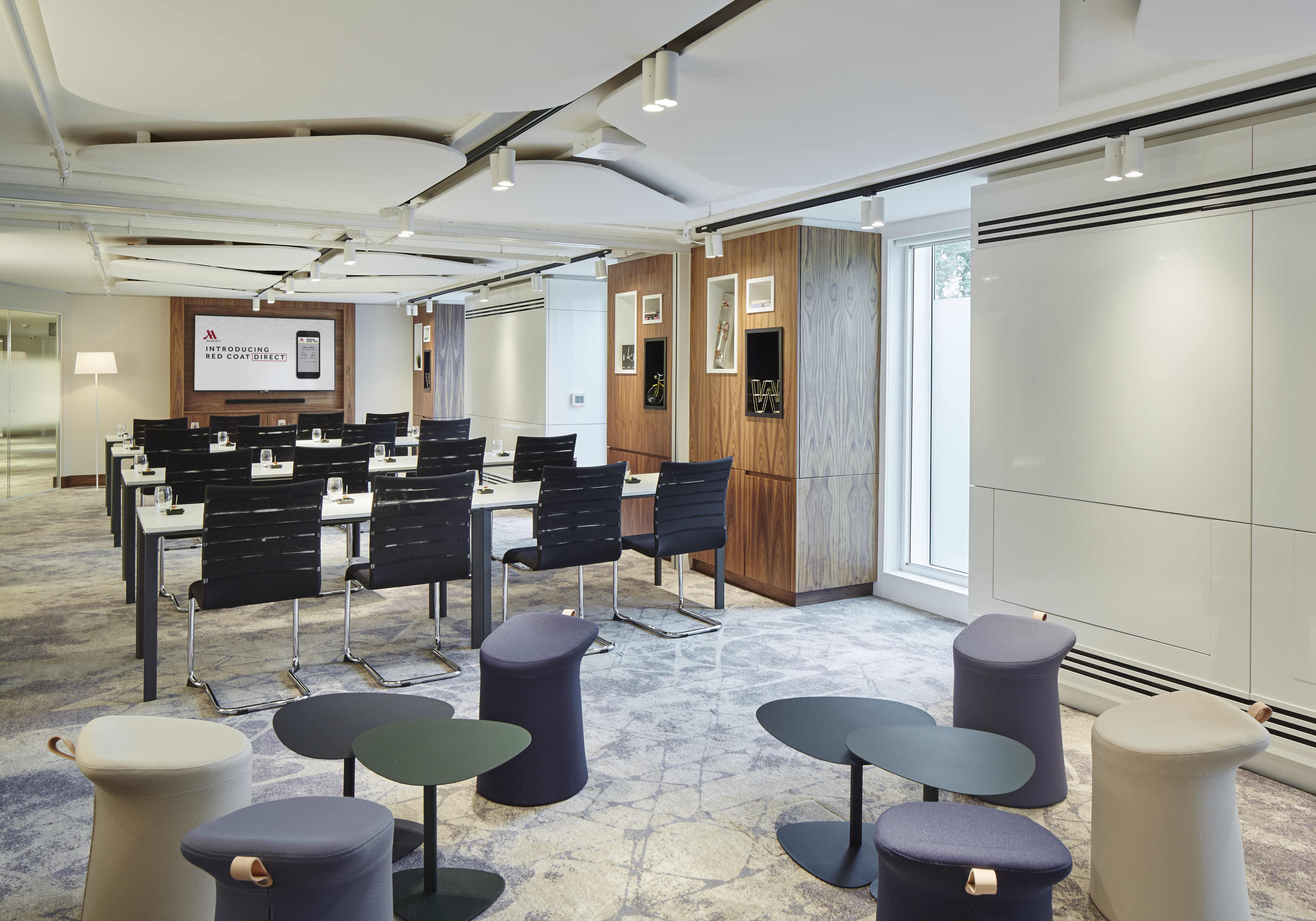 Modern meeting room at London Heathrow Marriott with flexible seating for events.