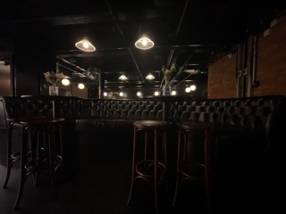 Intimate Whiskey Jar Basement venue with sleek leather seating for networking events.