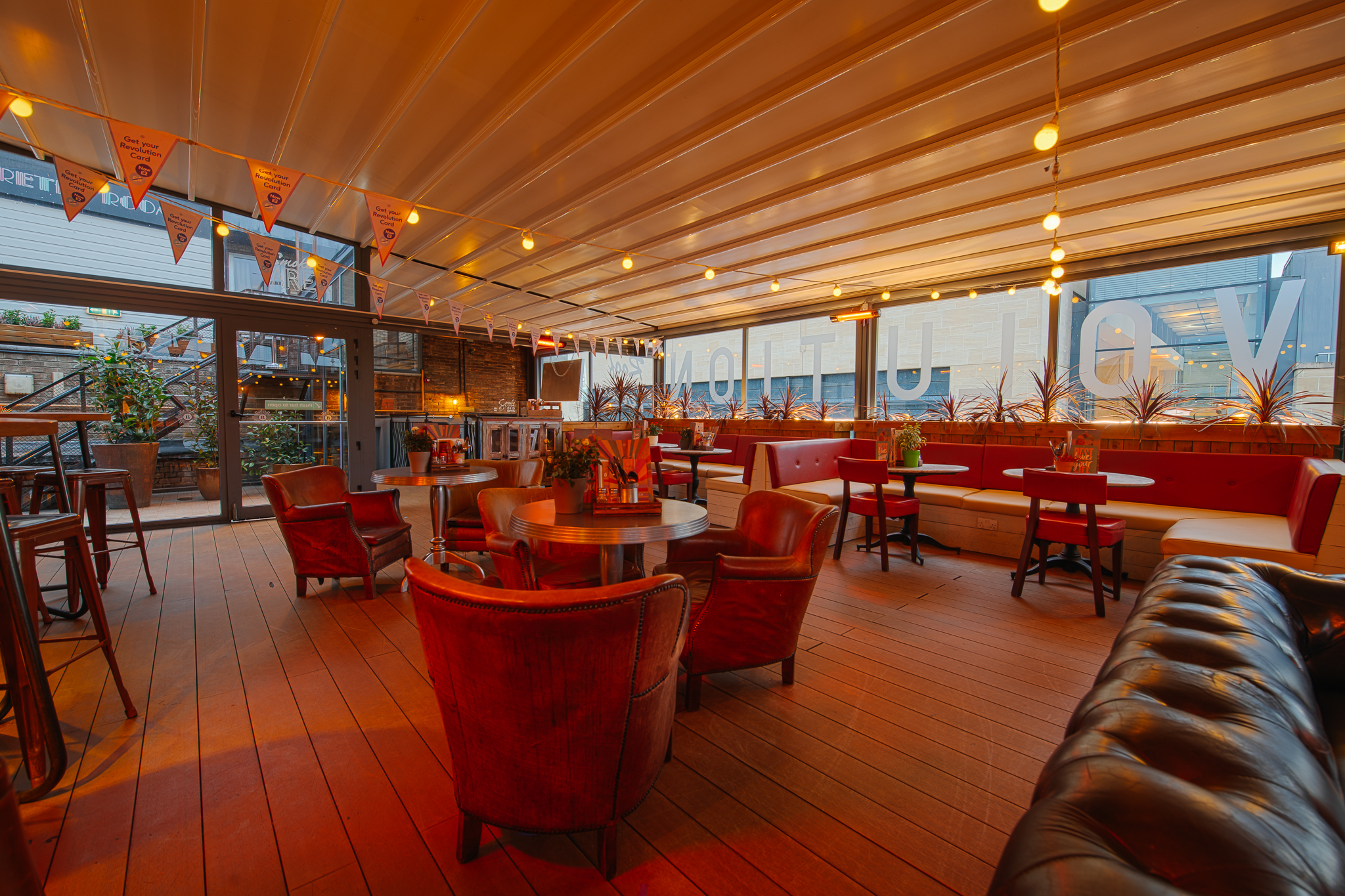 Rooftop Bar in Revolution Cambridge, stylish event space with warm lighting for gatherings.