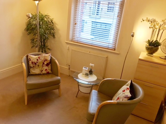Cozy meeting room with soft lighting and plants for intimate discussions at Wilbraham Place.