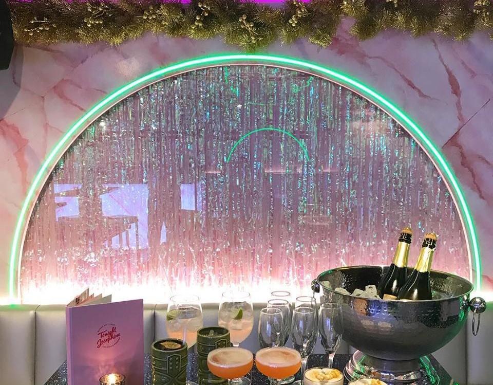 Elegant event setup at Tonight Josephine Shoreditch with shimmering backdrop and drinks.