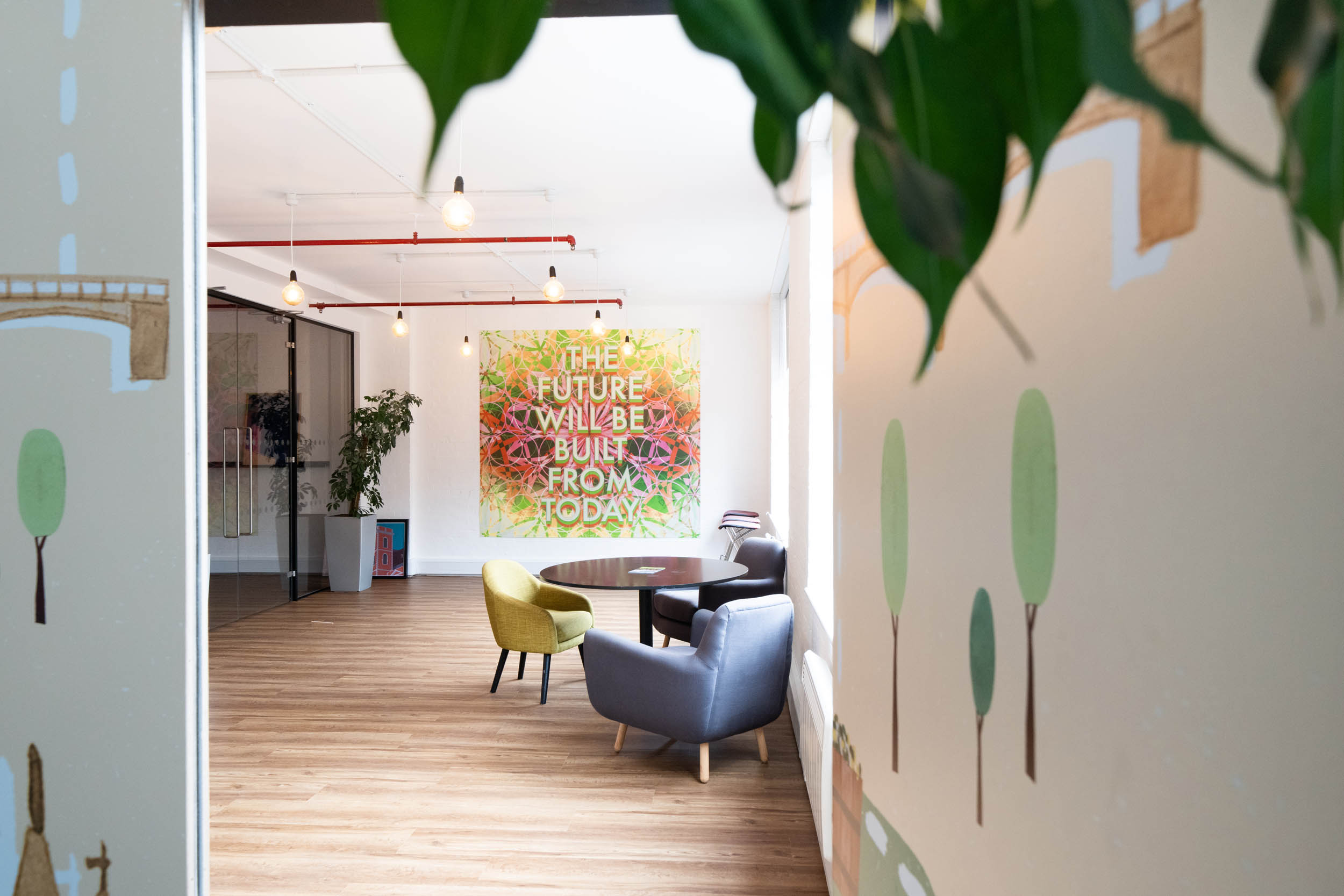 Modern meeting space at The Hive, London Bridge, with vibrant mural for creative workshops.