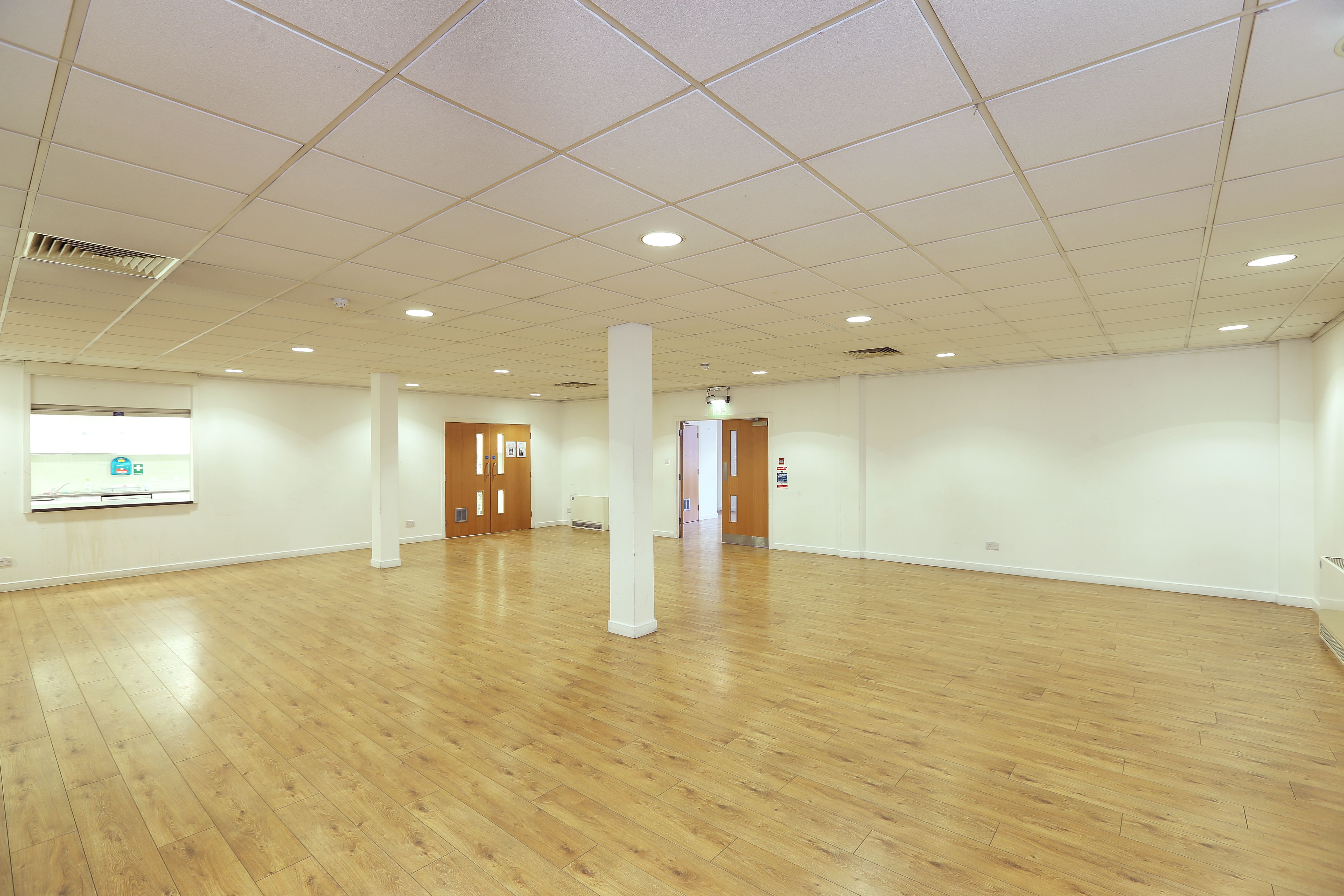 Spacious event space in St George the Martyr Church with polished wooden floors.