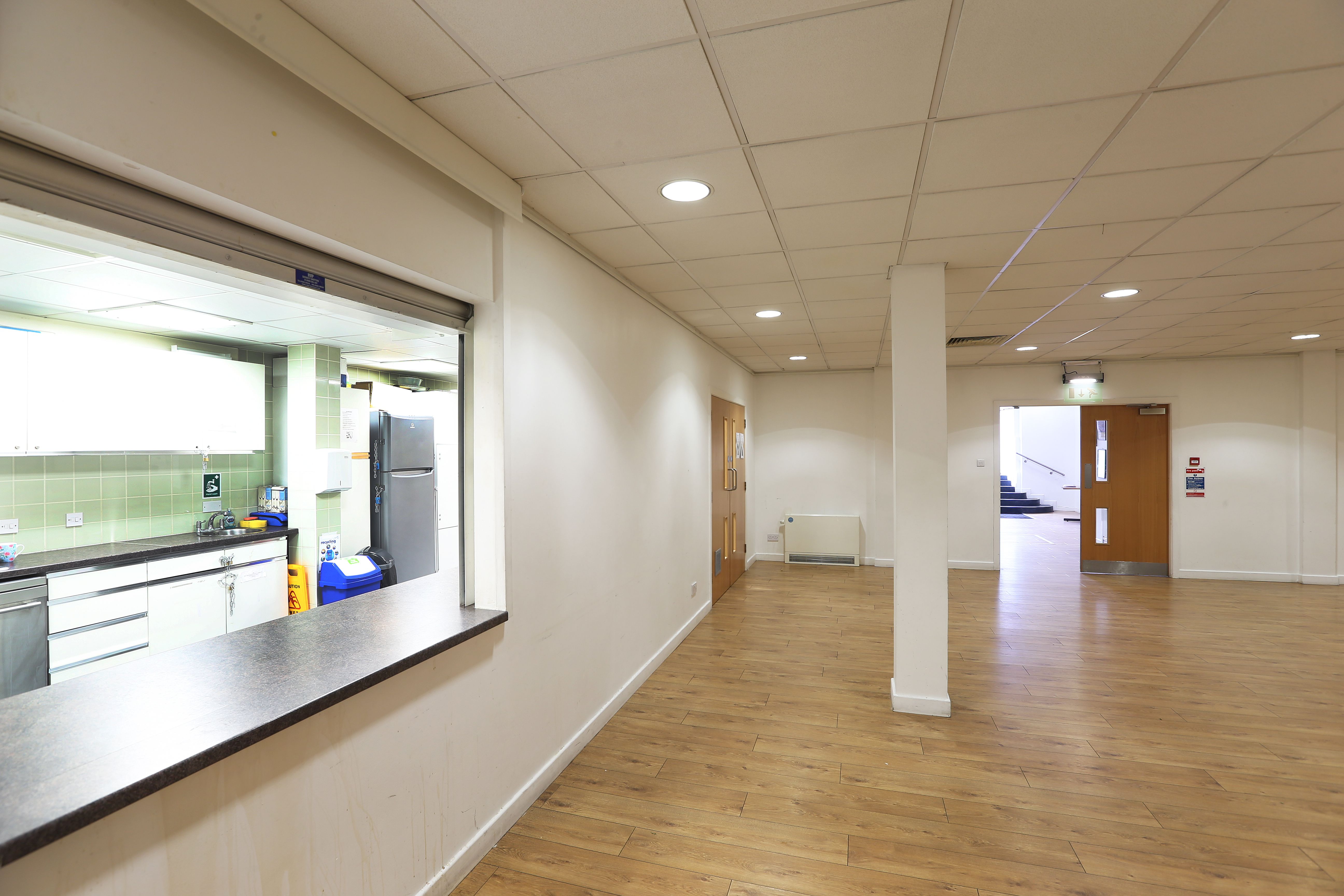 Versatile event space in St George the Martyr Church with natural light and kitchen access.