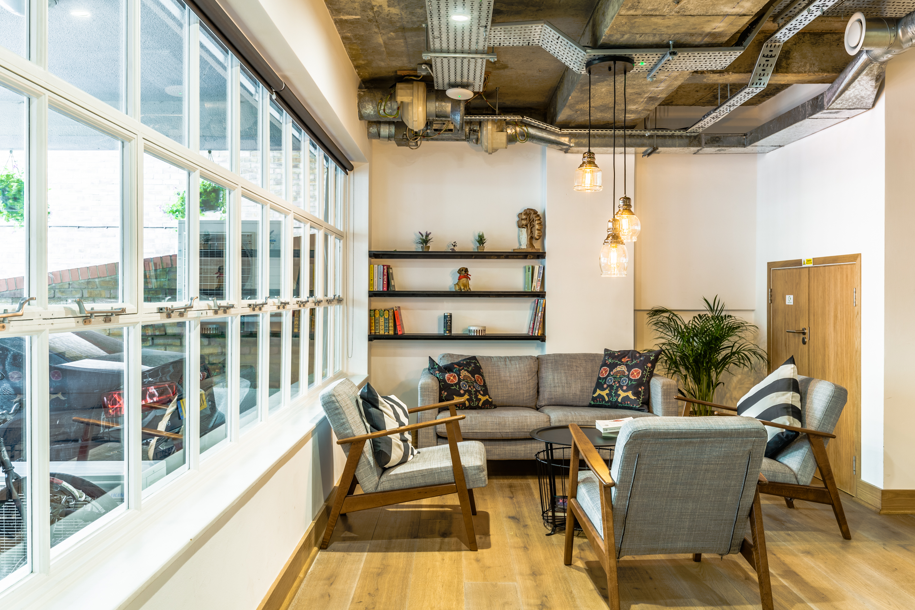 "Bright cafe venue break-out area with modern decor for meetings and networking."
