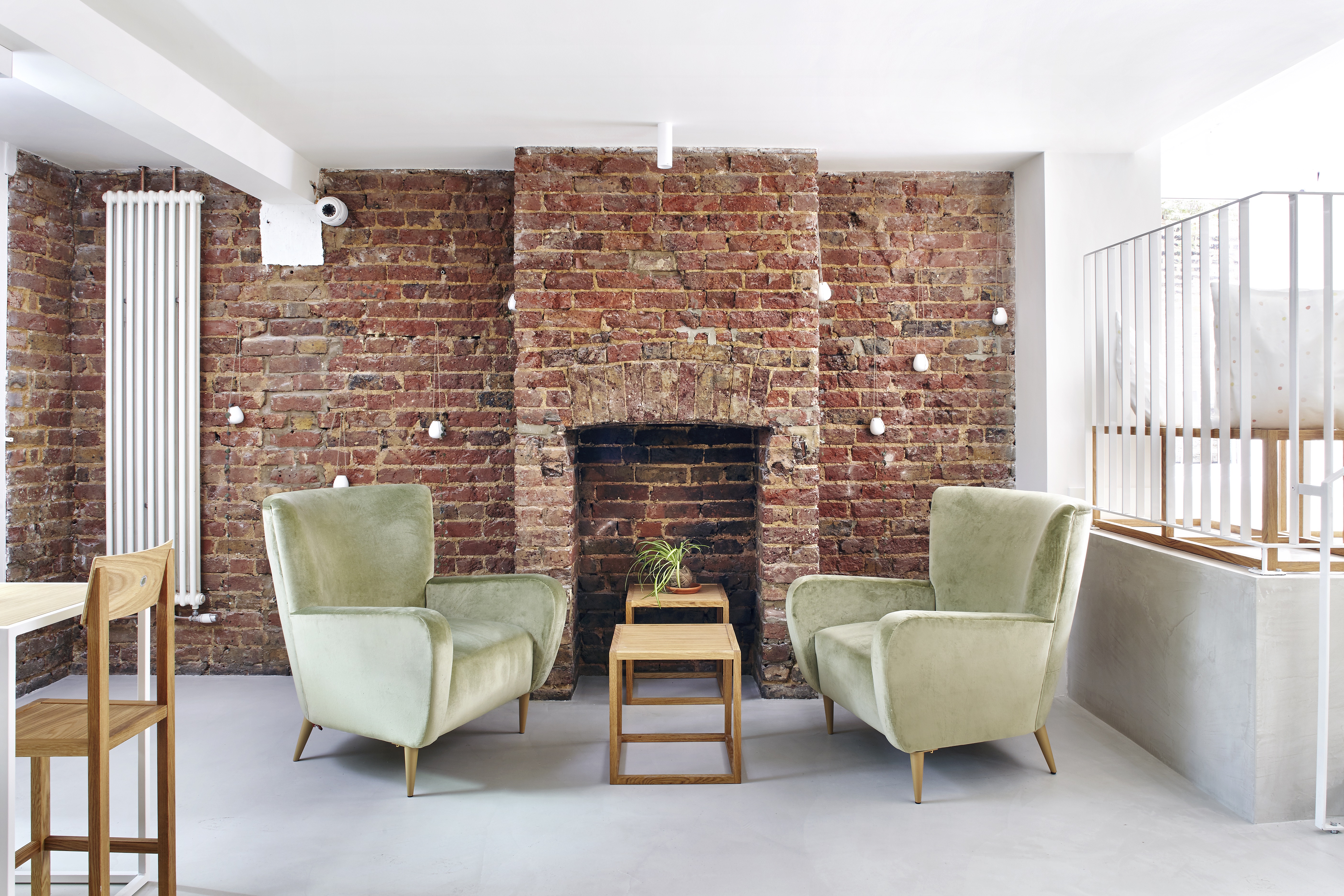 Stylish meeting space with plush armchairs at Unico Notting Hill for casual gatherings.