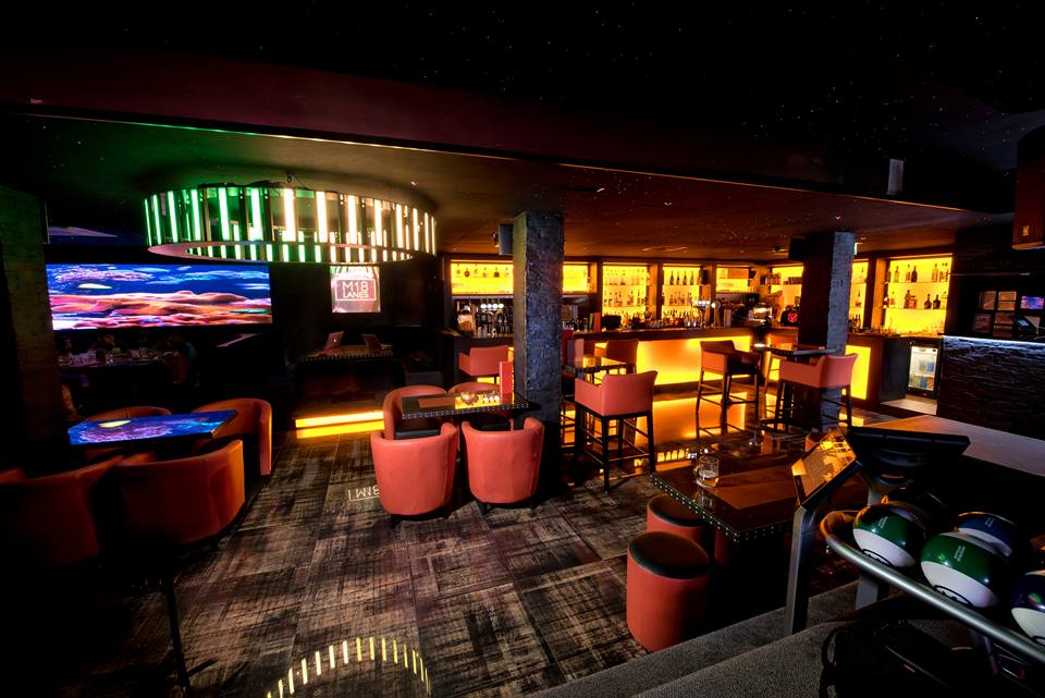 Modern bowling lanes in a stylish lounge, perfect for networking events and cocktail receptions.