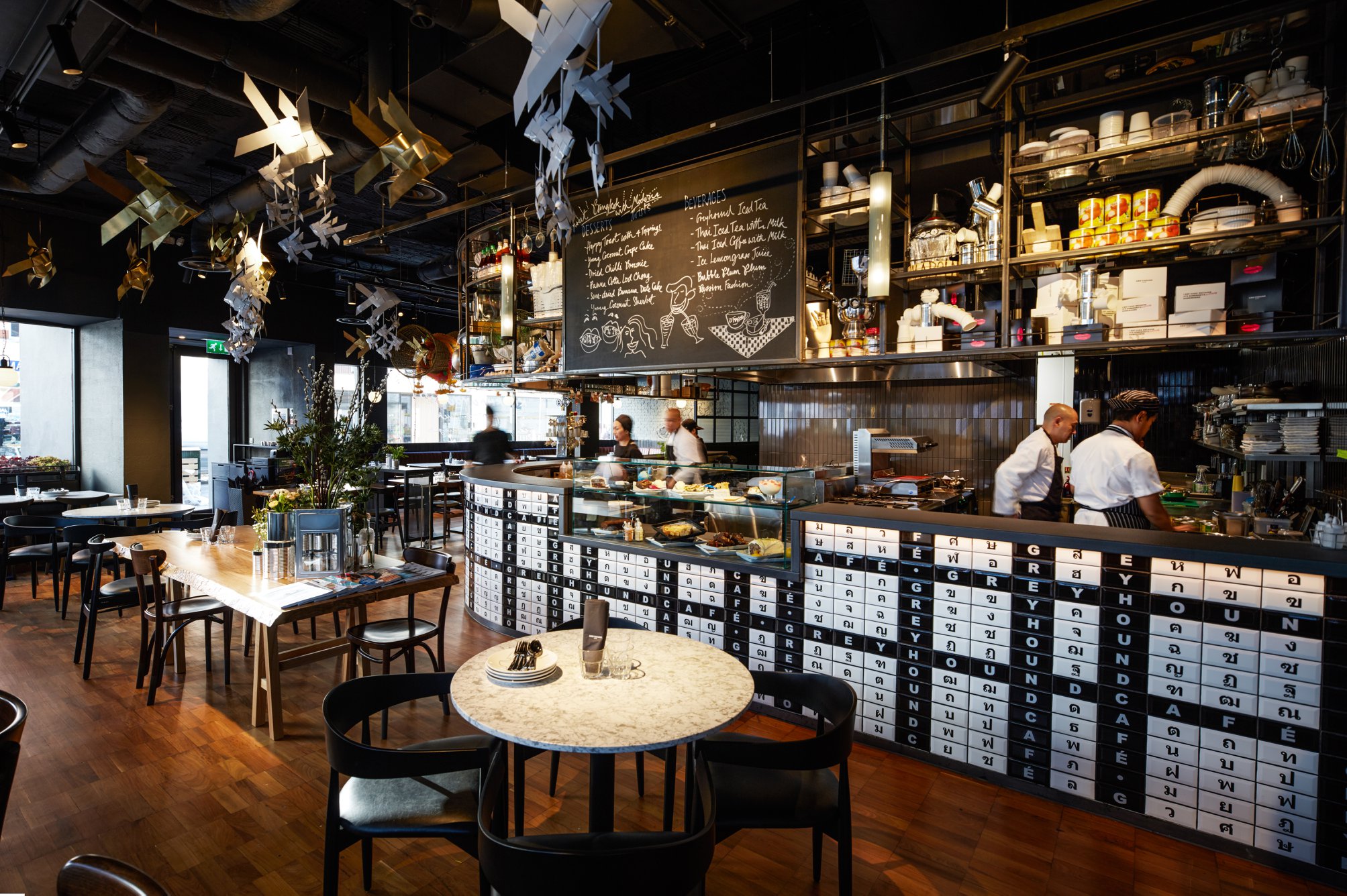 Modern restaurant interior with open kitchen, perfect for gatherings and meetings.