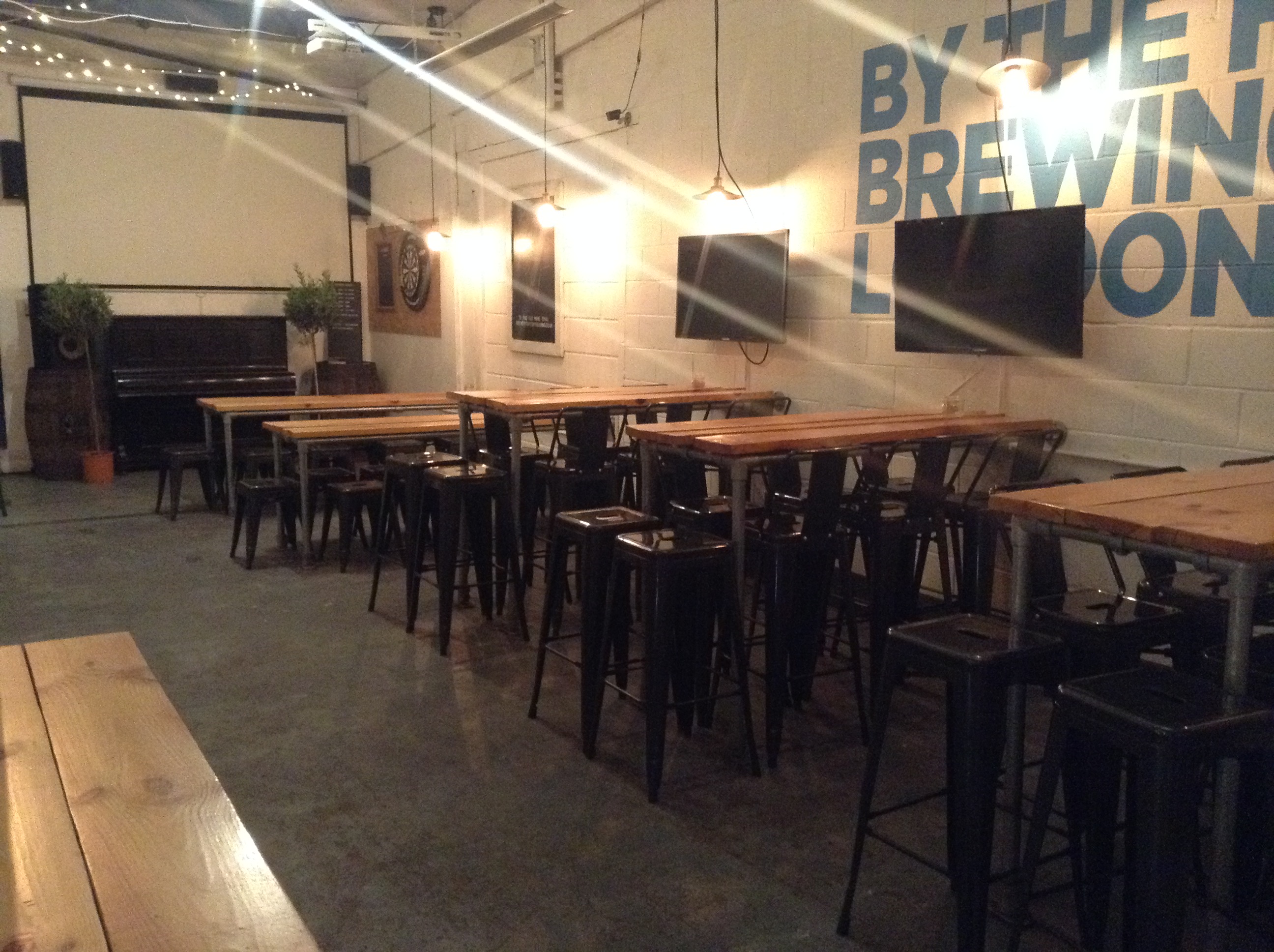 Taproom Bar at By The Horns Brewing Co., modern industrial event space for networking and workshops.