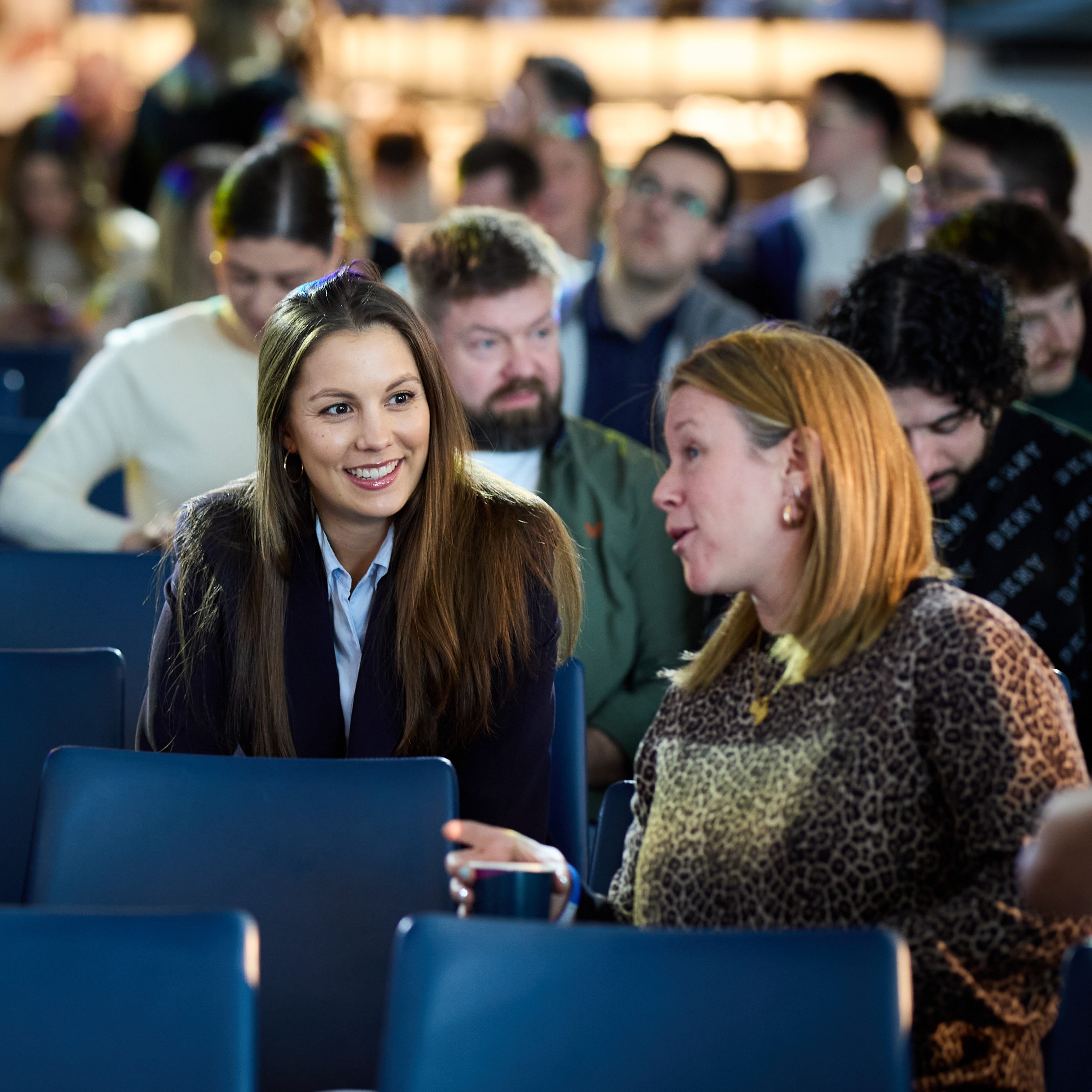 Attendees networking at a conference in Tottenham Hotspur Stadium's East Quarter Level Three.