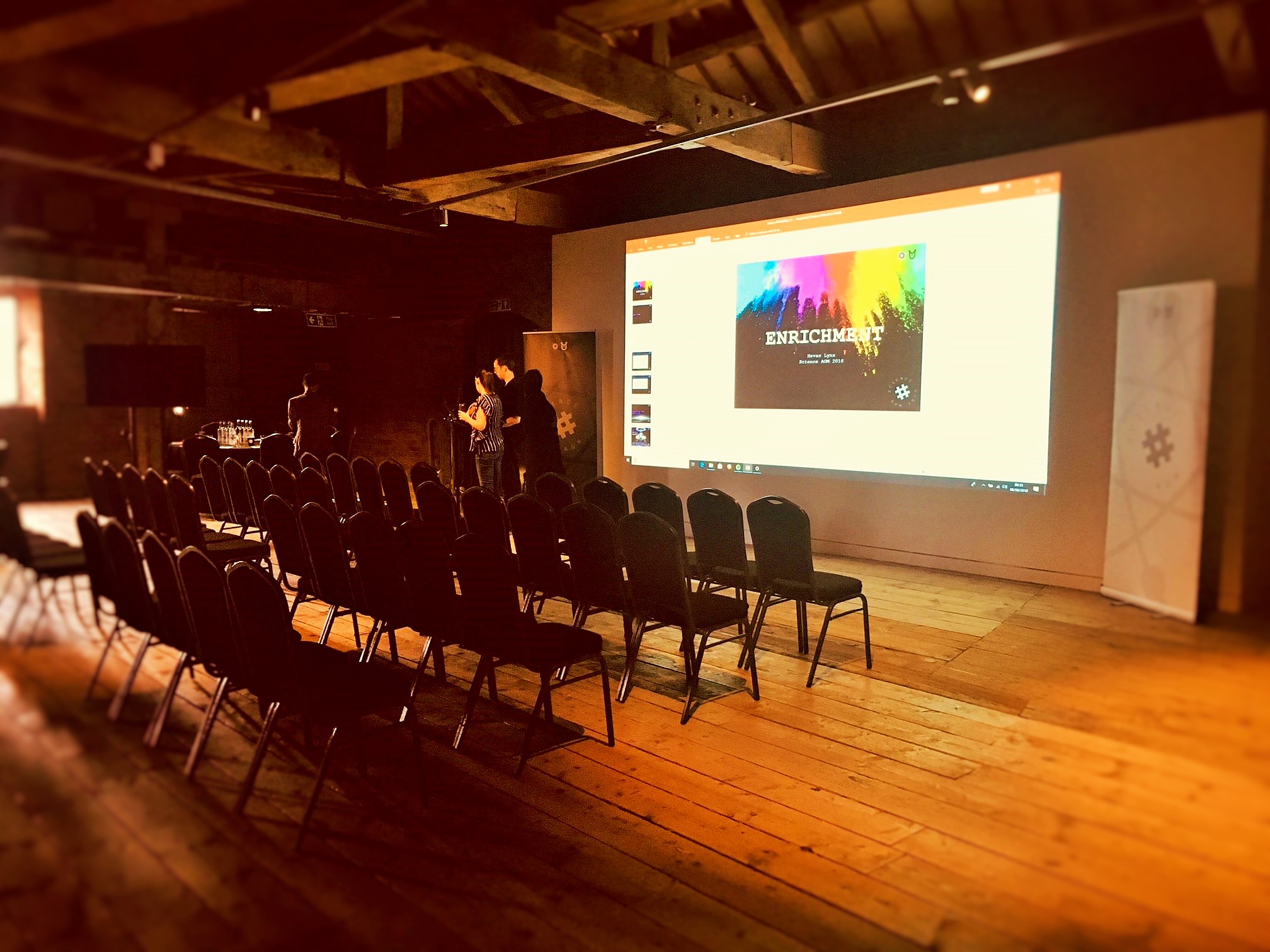 Event space at 1830 Warehouse with chairs and projection screen for workshops.