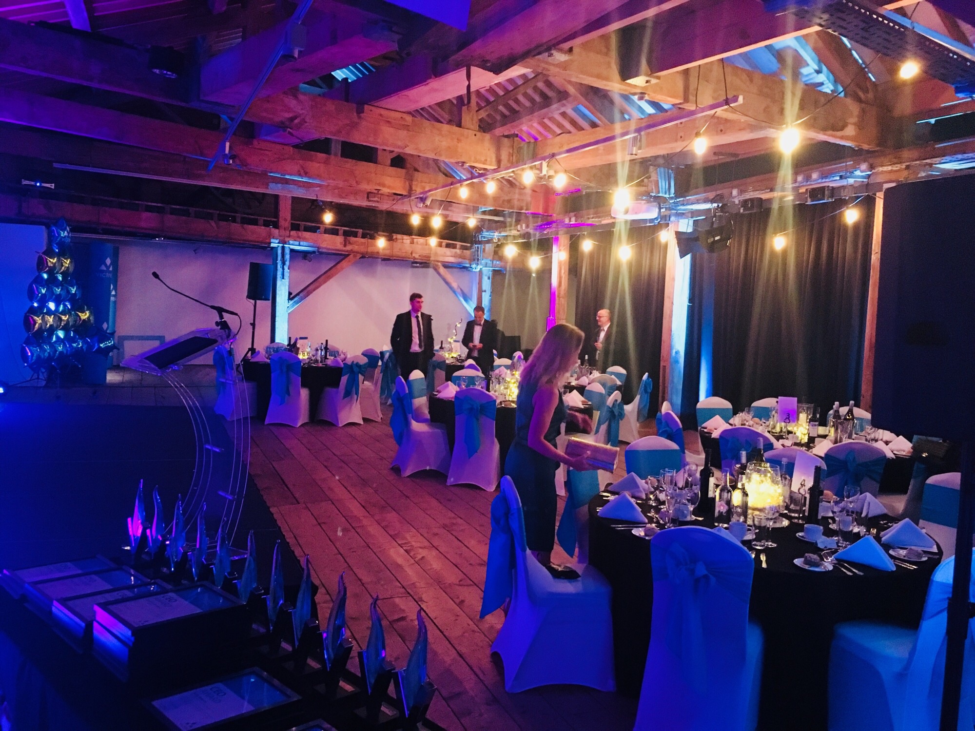 Elegant 1830 Warehouse event space with blue accents for gala or awards ceremony.