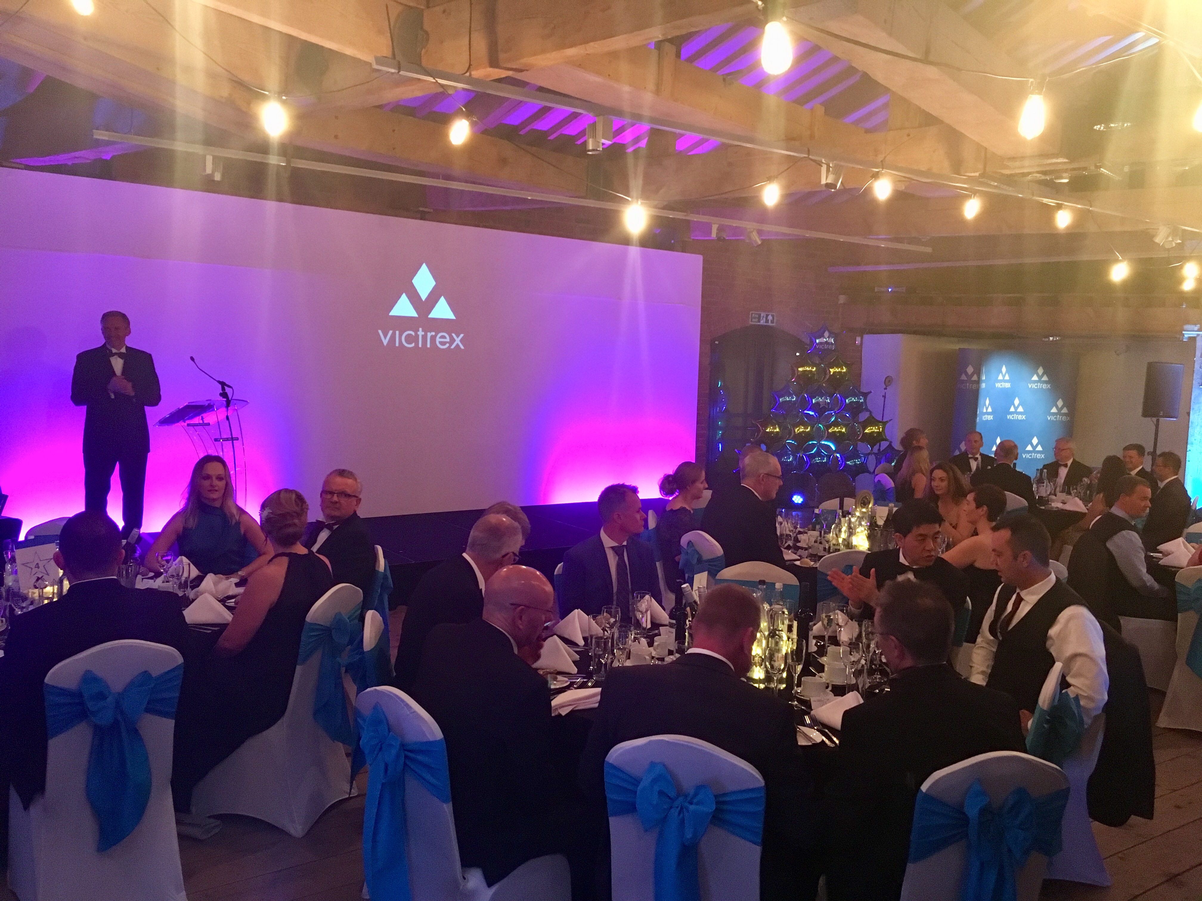 Corporate dinner event at 1830 Warehouse, featuring elegant table arrangements and networking.