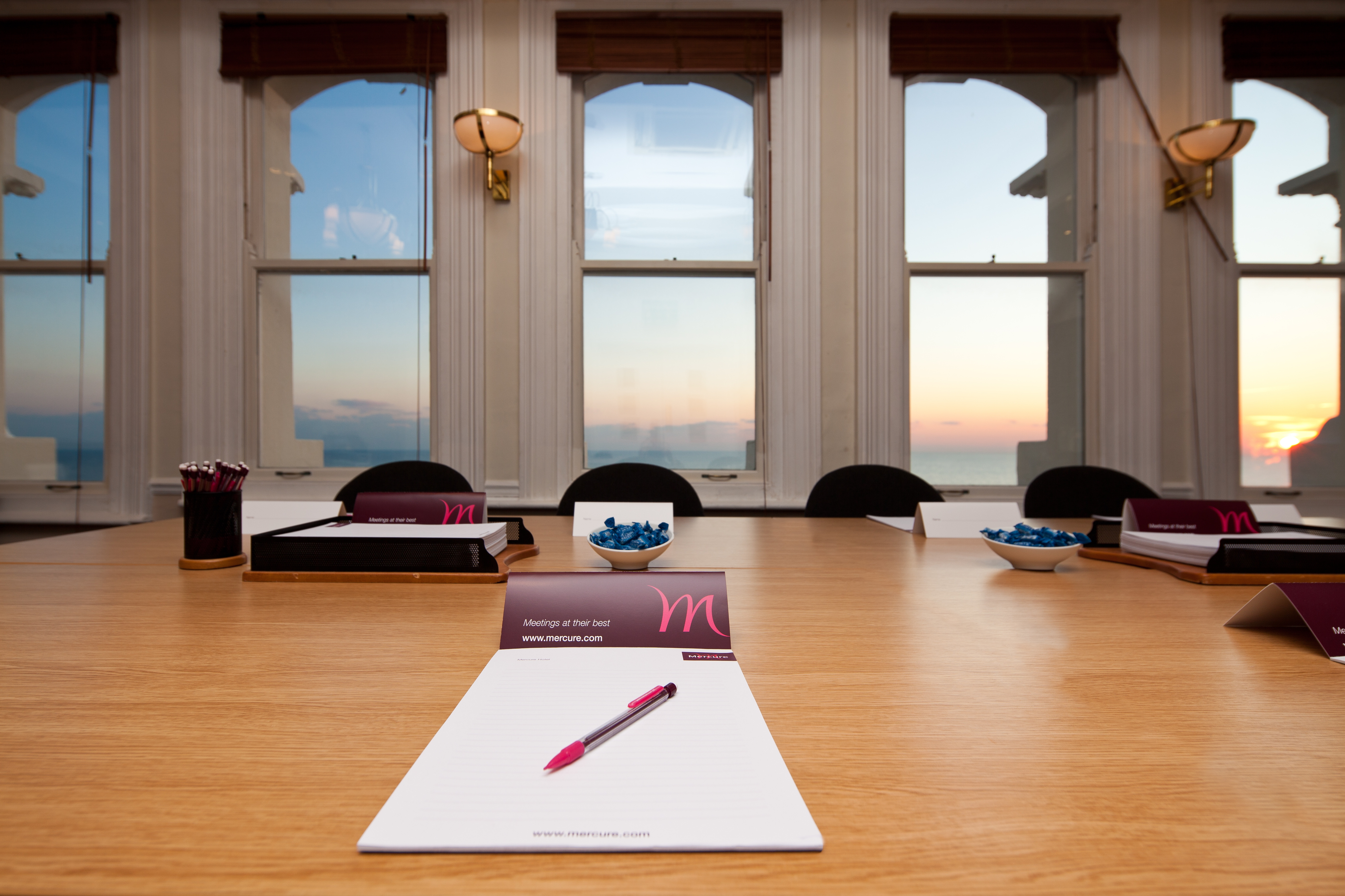 Coast View meeting room at Mercure Brighton, featuring a polished wooden table and sea view.