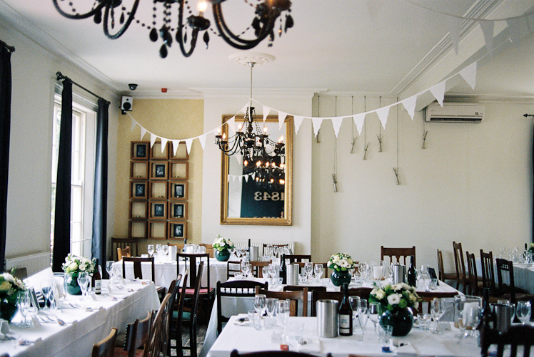 Elegant event space with floral centerpieces for weddings and corporate functions.