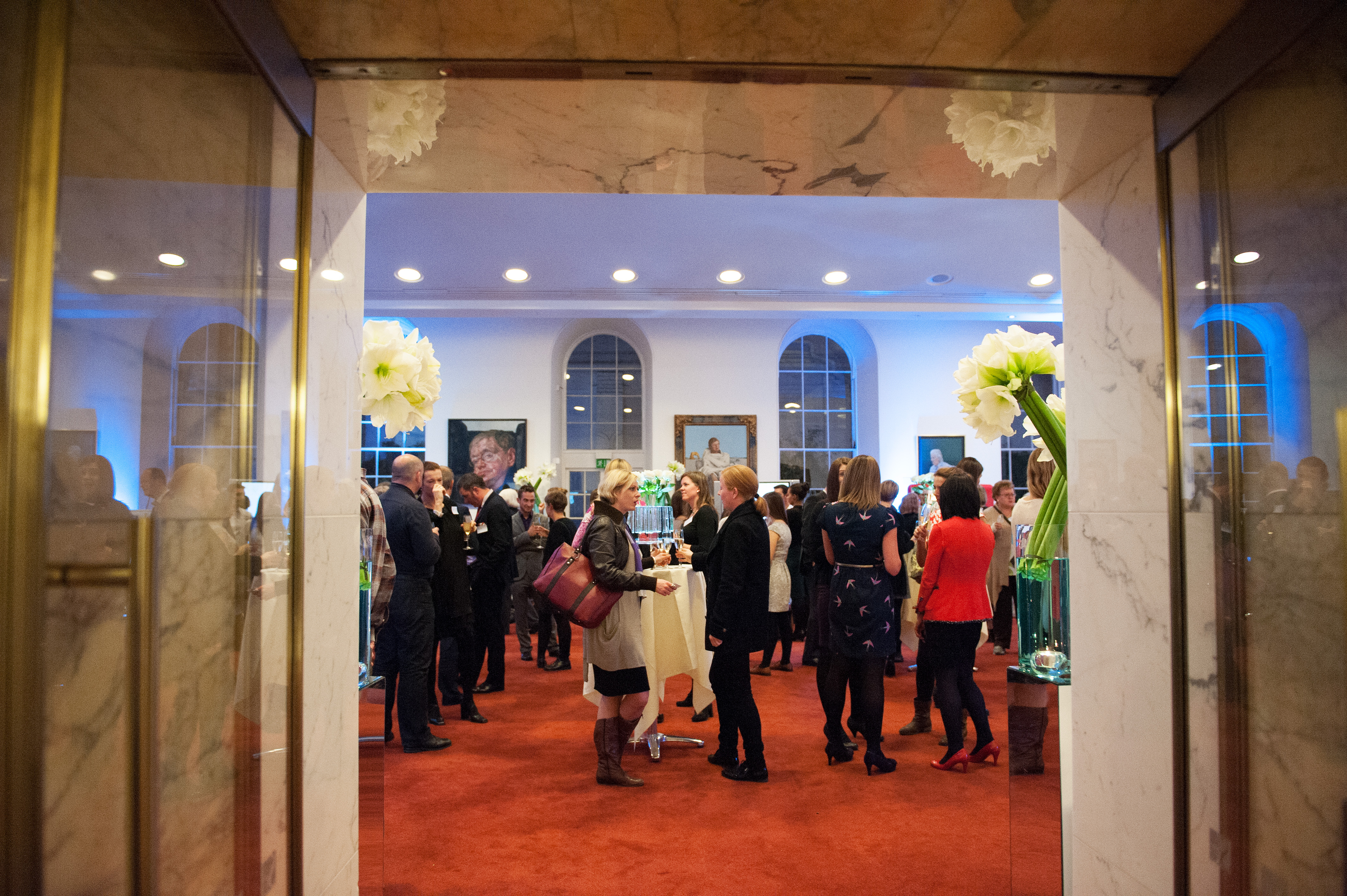 Vibrant networking event in The Royal Society's elegant dining room with floral decor.