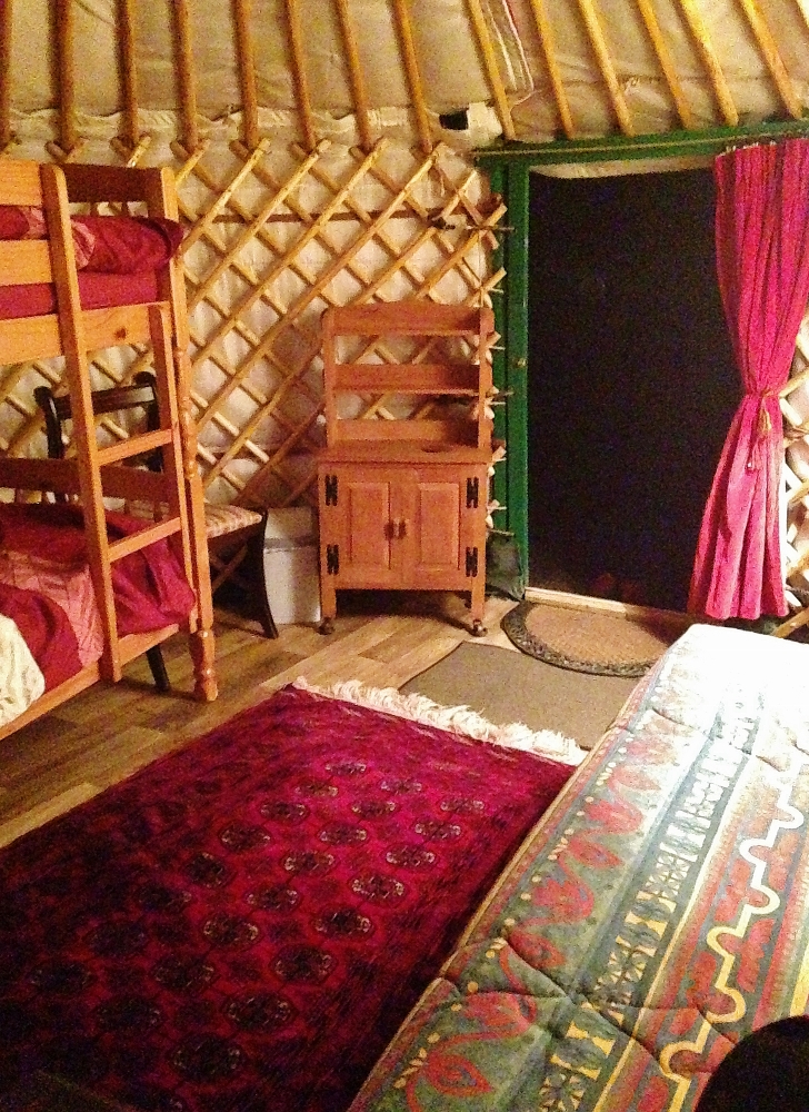 Cozy yurt interior at Barnutopia, perfect for retreats and intimate gatherings.