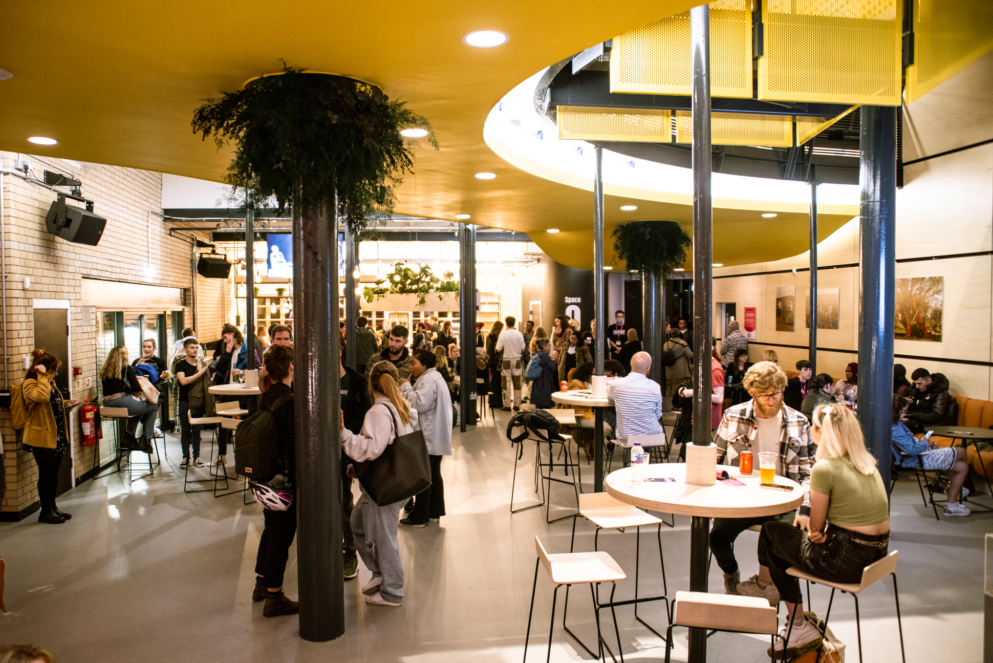 Vibrant event space with high tables for networking at Contact Theatre.