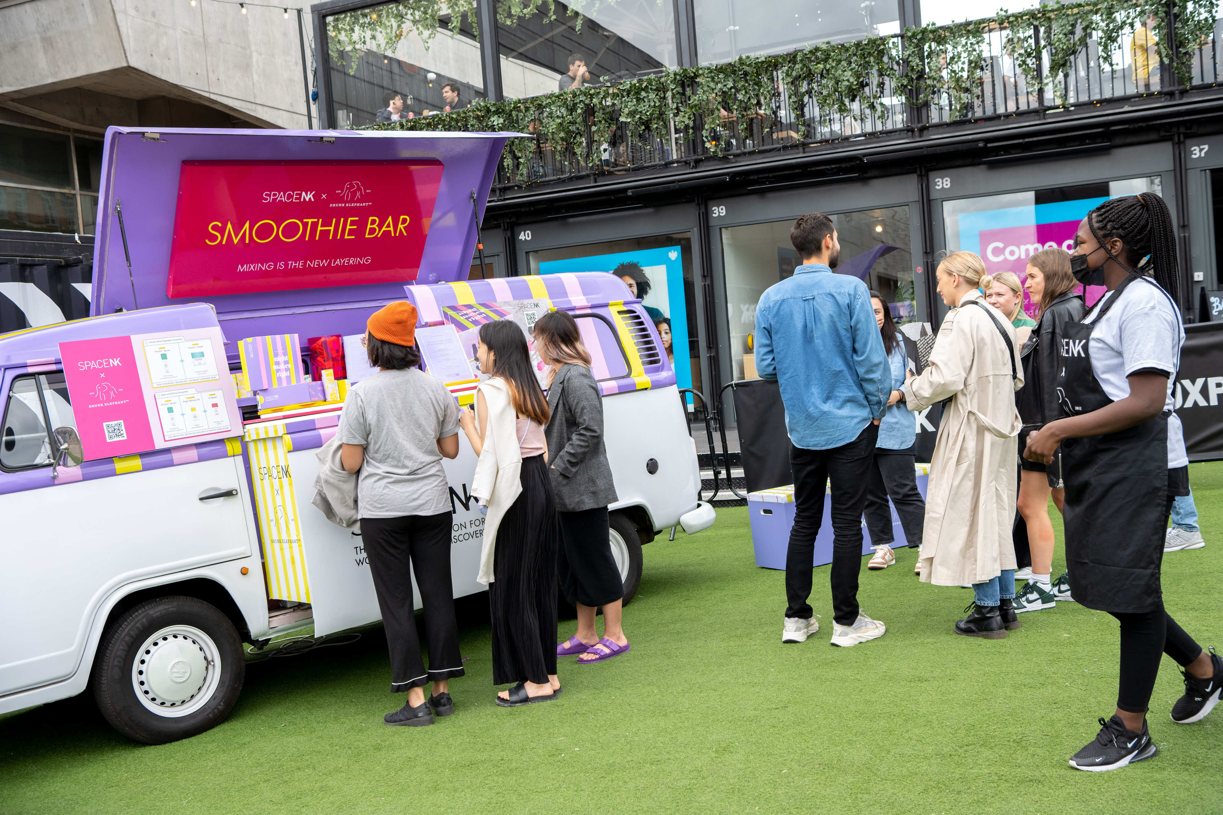 Vibrant outdoor event at BeatBox, featuring a smoothie bar for networking and socializing.