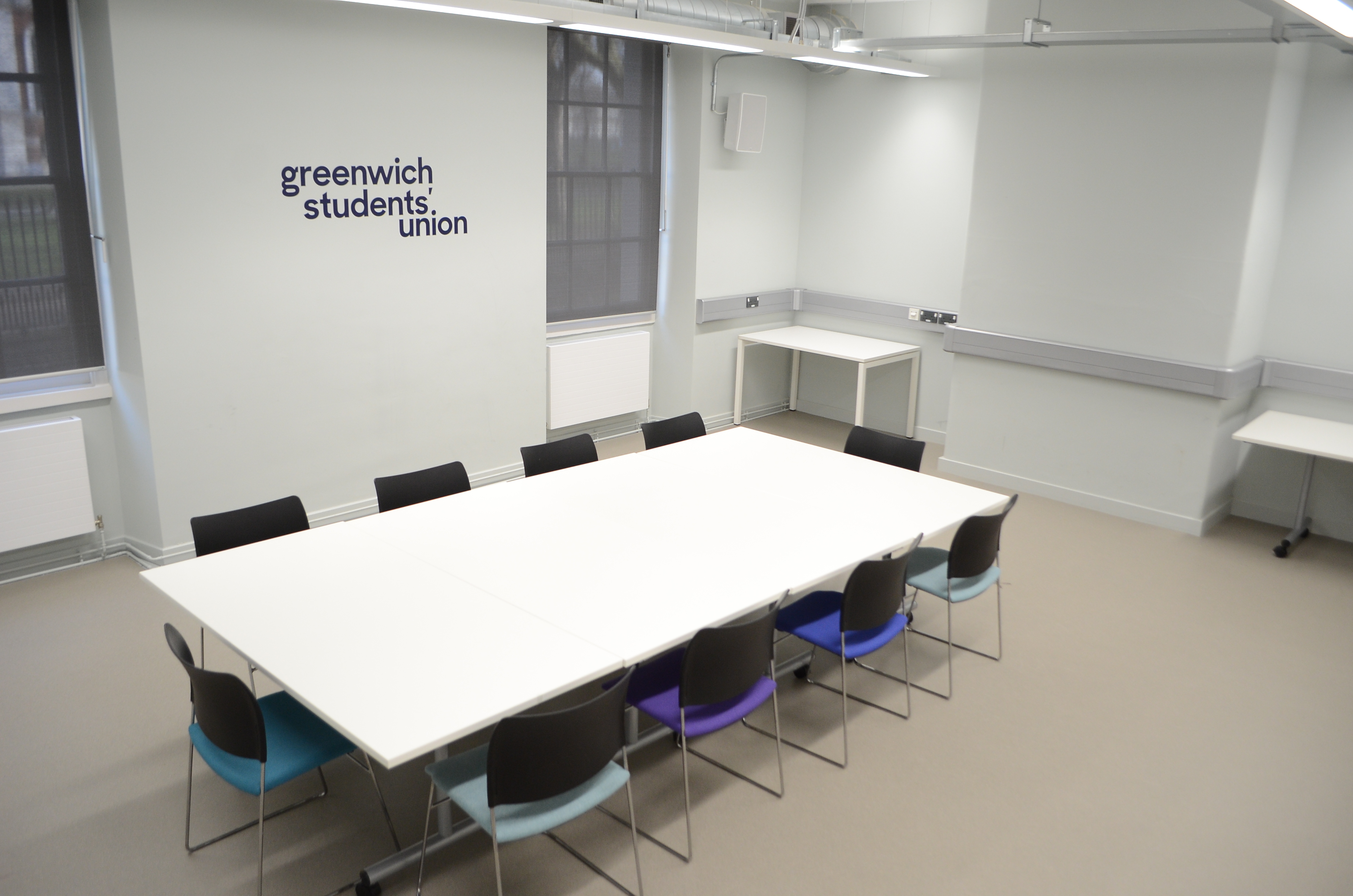 Large Meeting Room in Dreadnought with colorful chairs, ideal for workshops and collaboration.