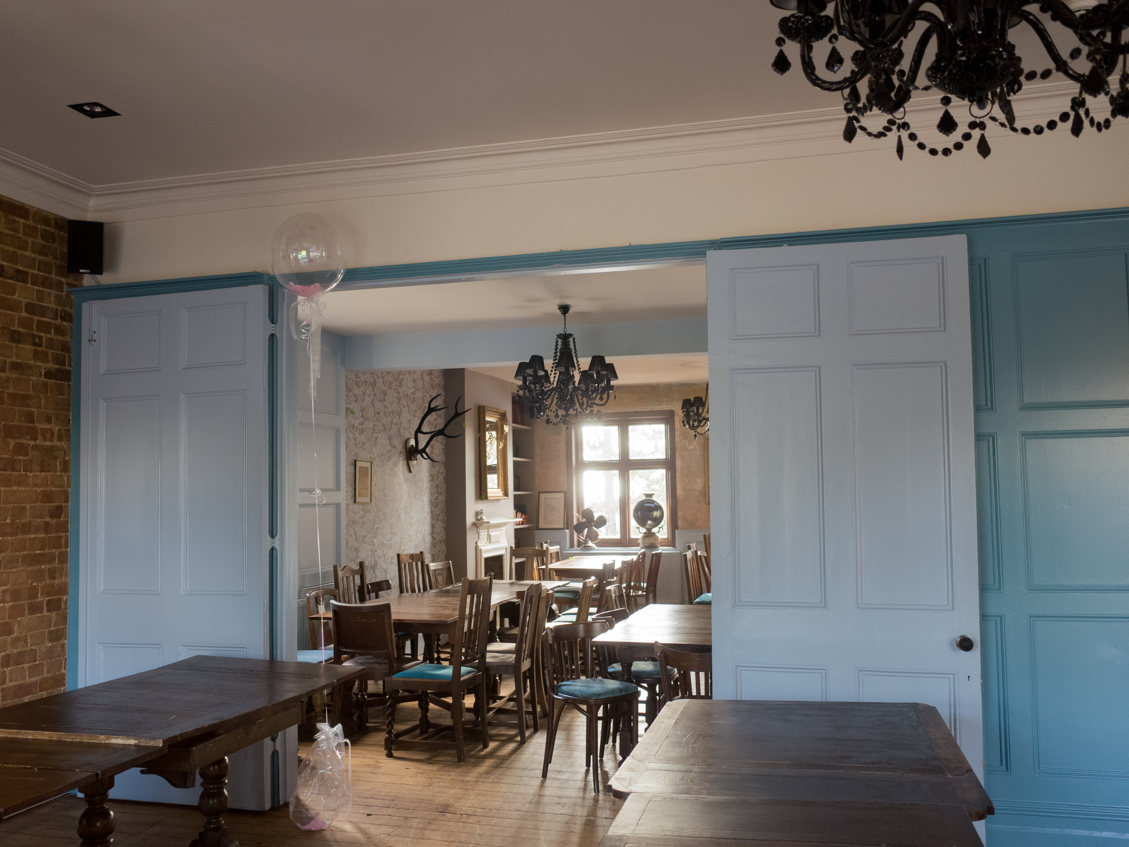 Function Room at Adam & Eve: rustic event space with elegant chandelier for gatherings.